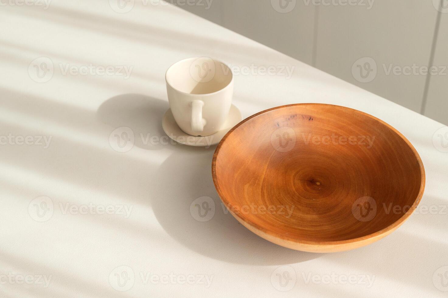 Step into elegant and clean kitchen with vintage charm. Simple and bright, round wooden tableware and utensils create still life of simplicity. hand made coffee cup and bowl. photo