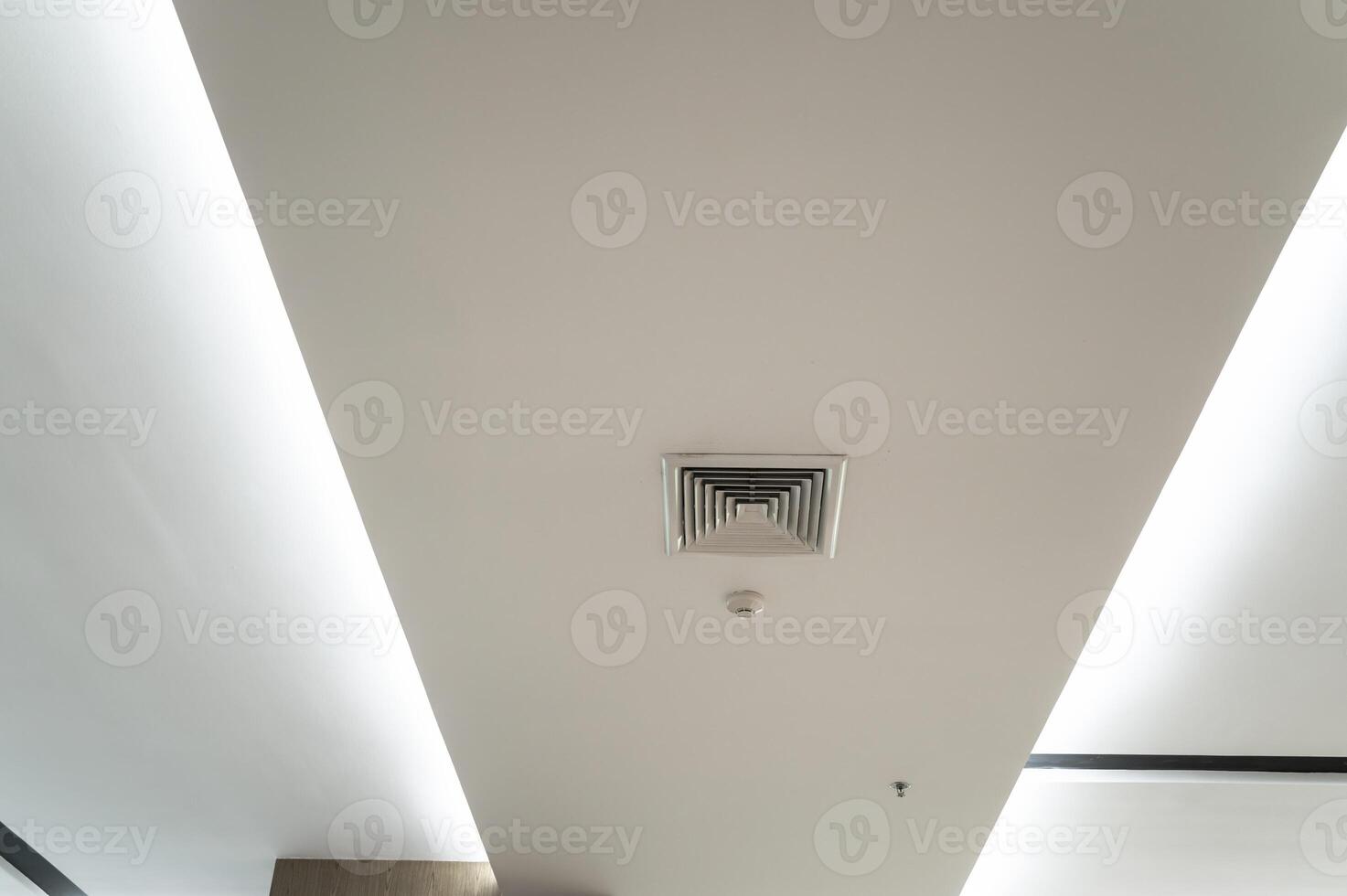 Ceiling mounted cassette type air conditioner and modern lamp light on white ceiling. Duct air conditioner for home, hall or office. photo
