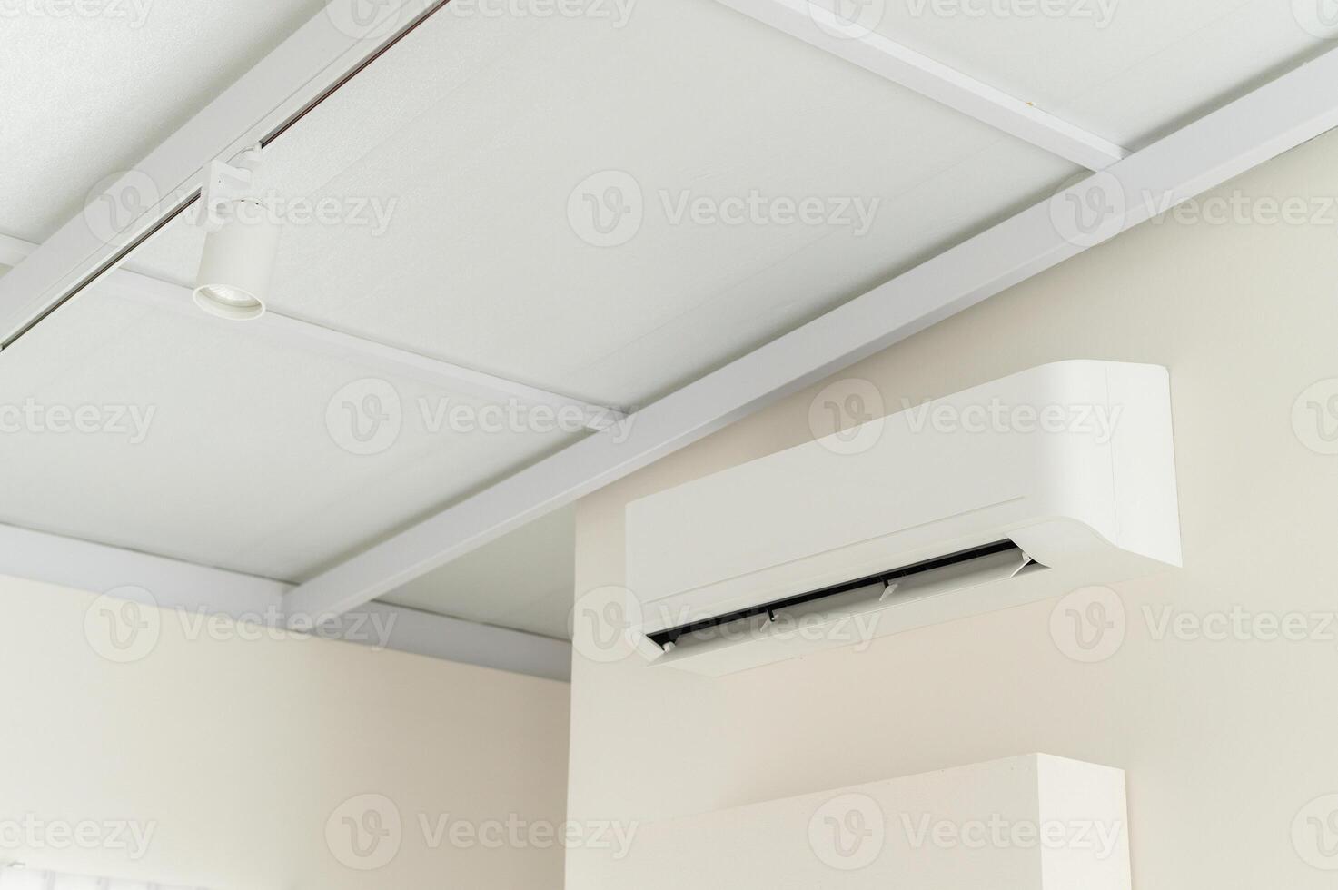 air conditioning system. pure indoor climate. With advanced technology and energy efficient operation, white room wall mounted unit ensures optimal temperature and ventilation. photo