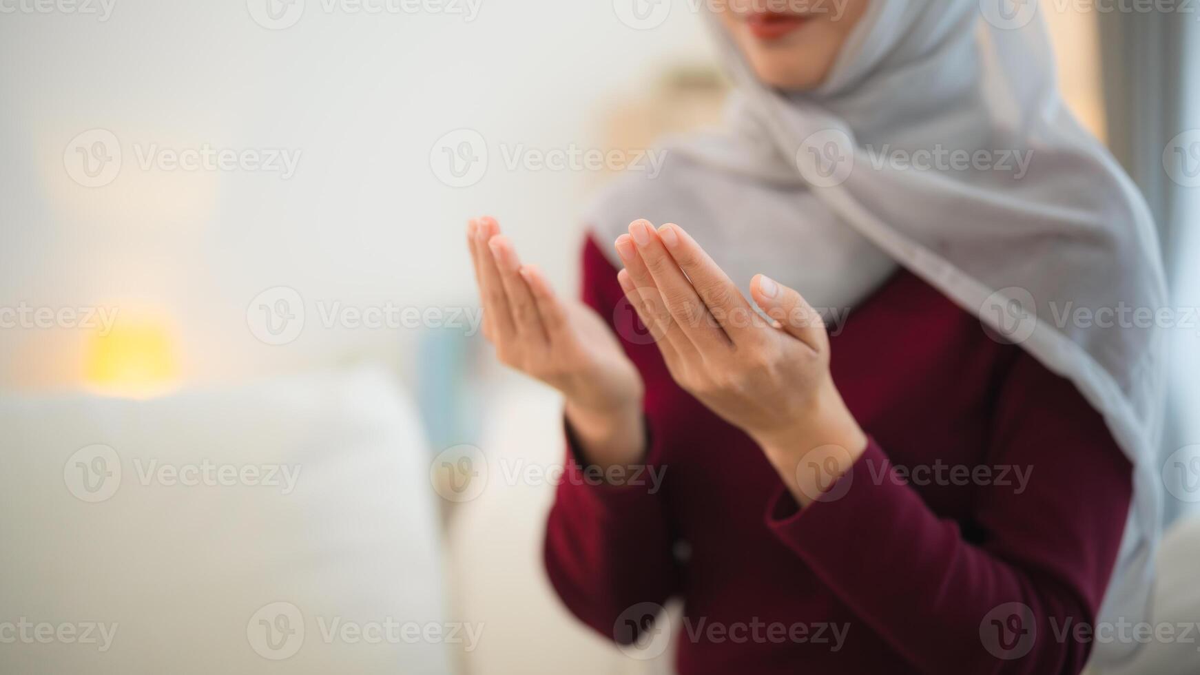 Close up hand. Muslim Islam woman with hijab do a day pray that show her believe in god. Muslim women praying in the living room at home. photo