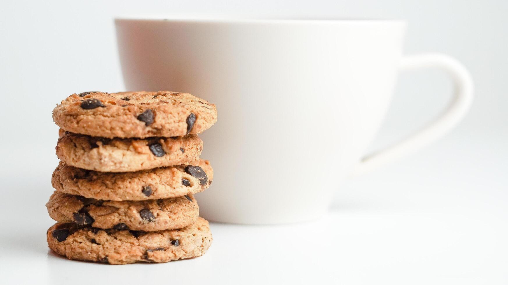 Chocolate chip cookies and a glass of milk coffee on a white background photo