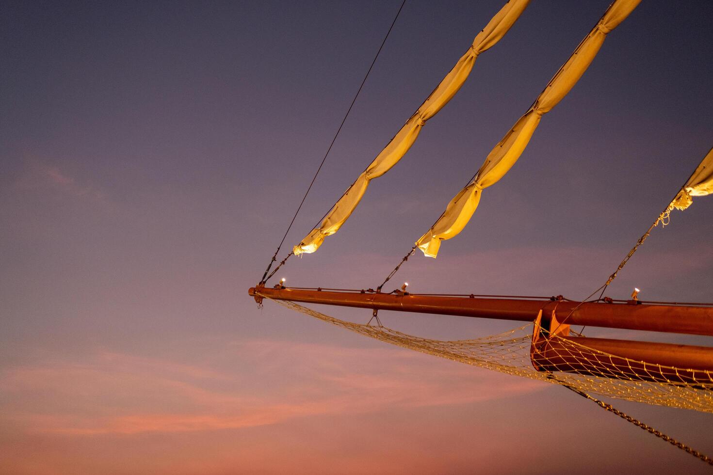 The tip of the boat has a canvas. Twilight sky background photo