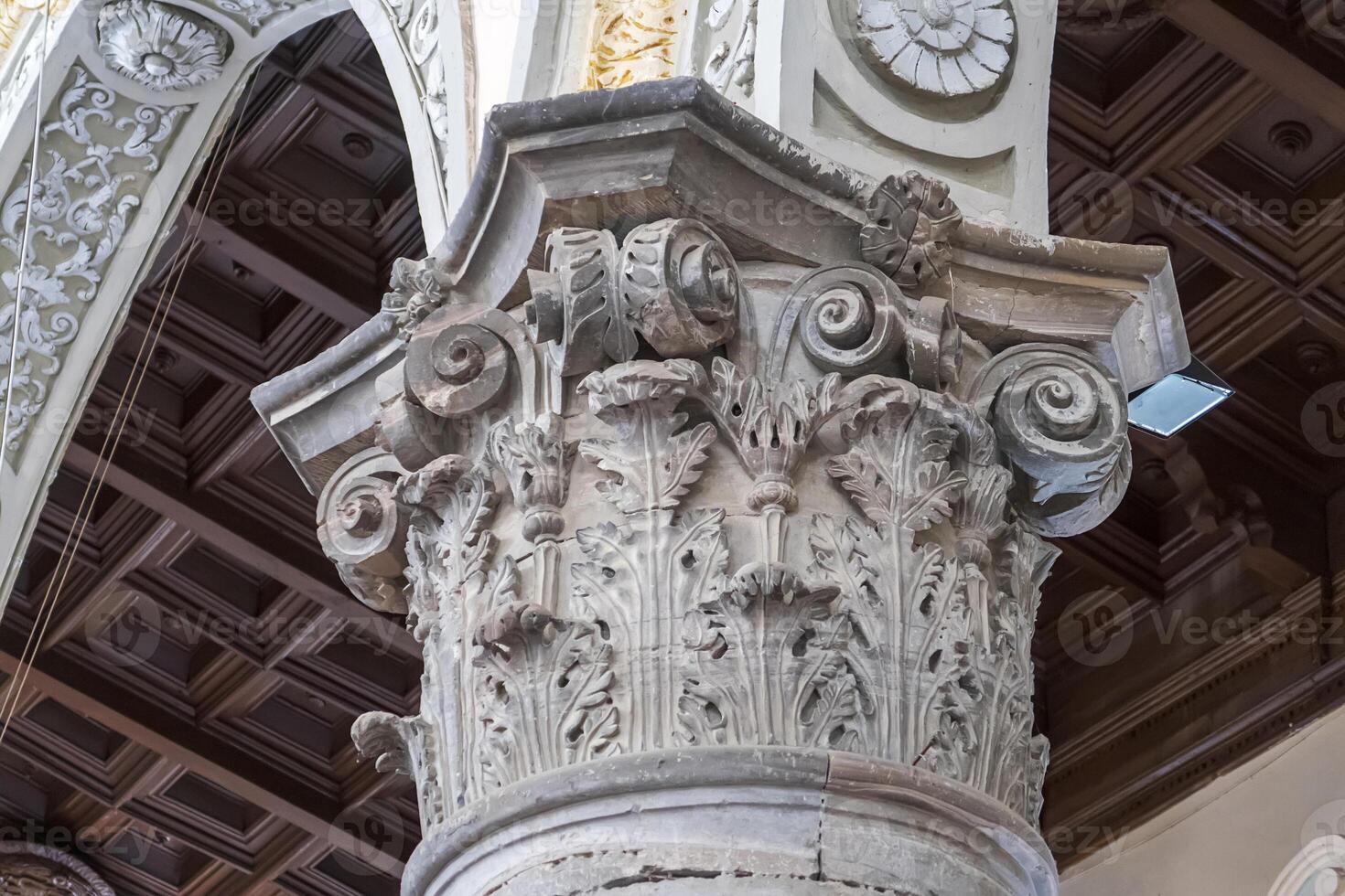 The capital of an old column in the church photo