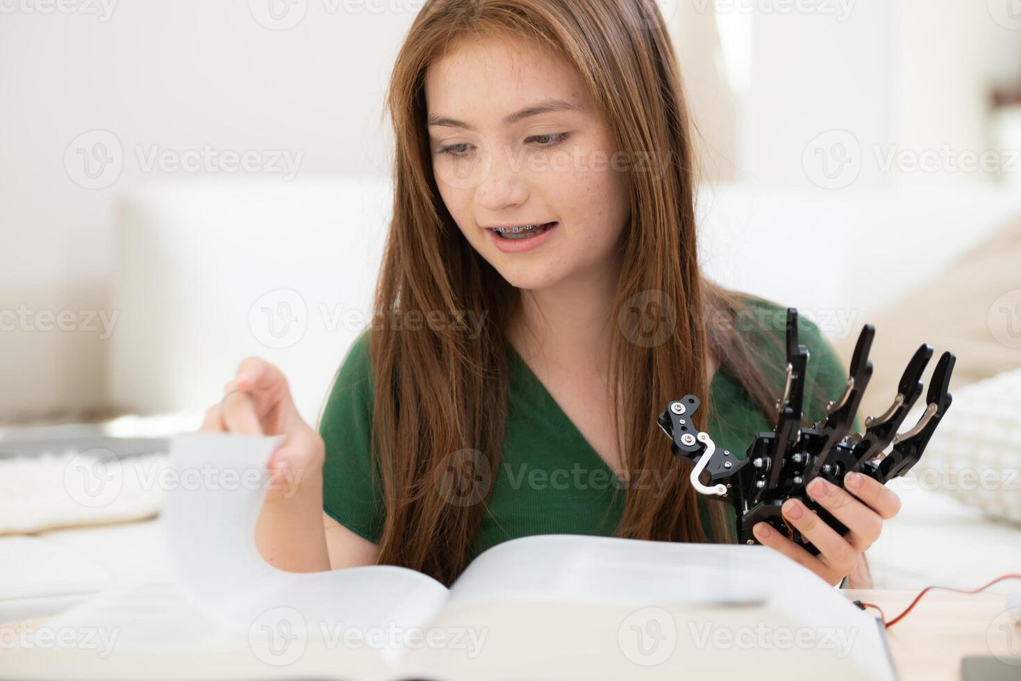 Portrait of Teenage girls students studying with hand robot model in the living room photo