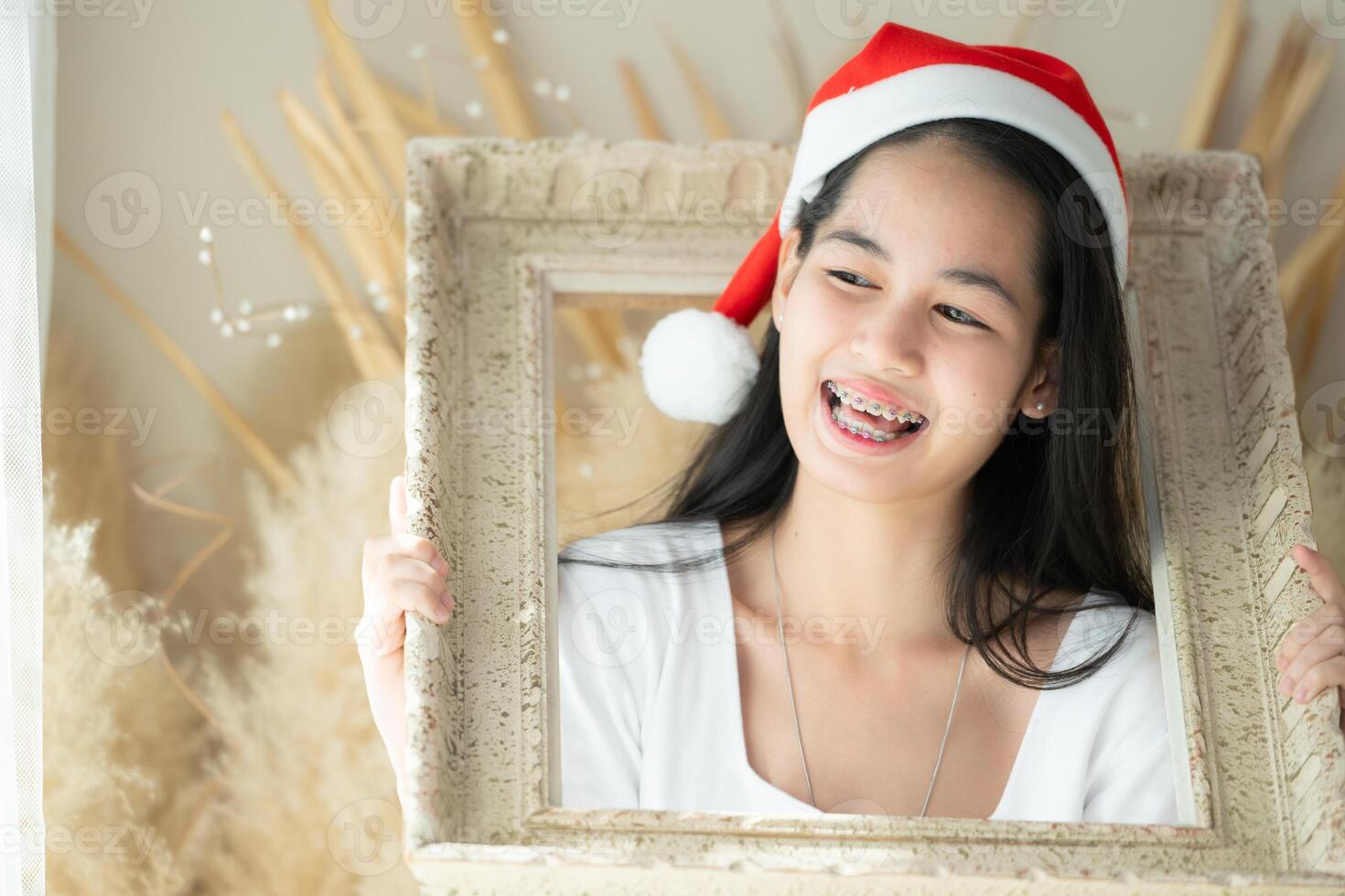 Portrait of Teenage girl with braces in picture frame photo