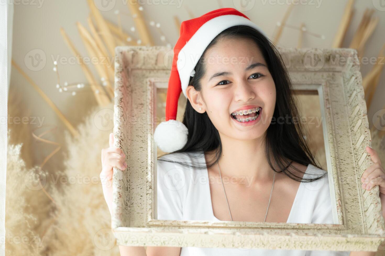 Portrait of Teenage girl with braces in picture frame photo