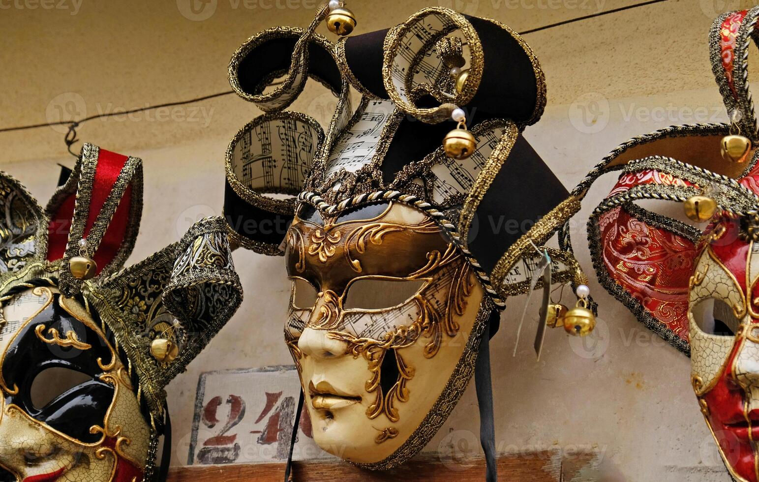 Traditional venetian masks on shelves in souvenirs shop in Venice, Italy. Beautiful carnival masks in variety of colours. Authentic and original Venetian full-face masks for Carnival. photo