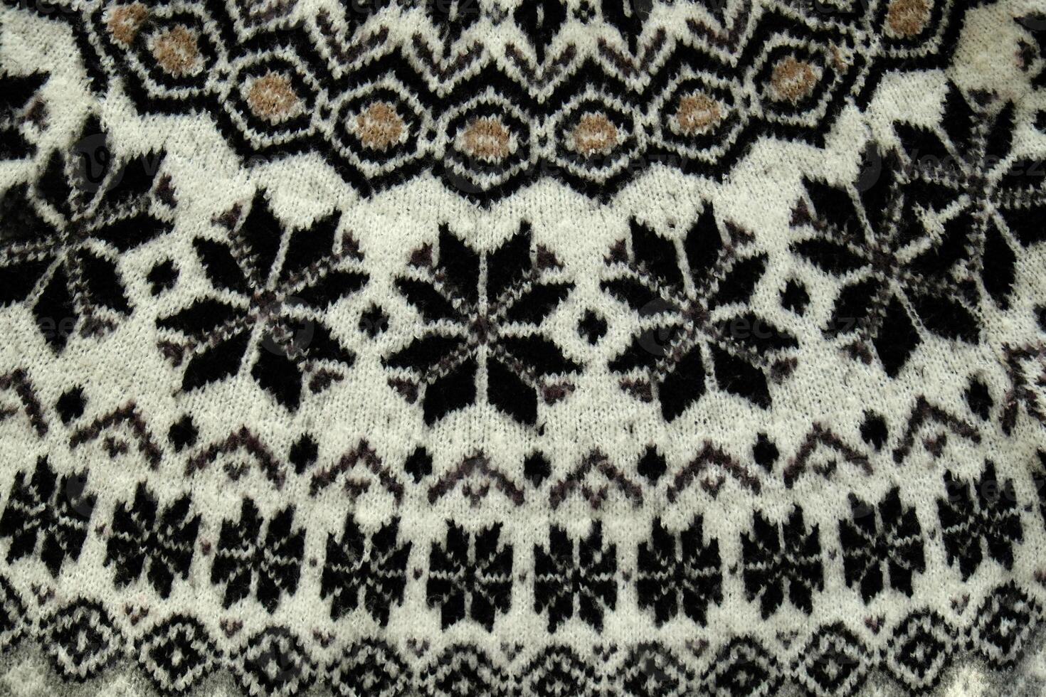 Black and white Winter Knitted Sweater Pattern Design with snowflakes. Handmade knitting wool fabric texture. Background of kniting patterns and ornament. photo