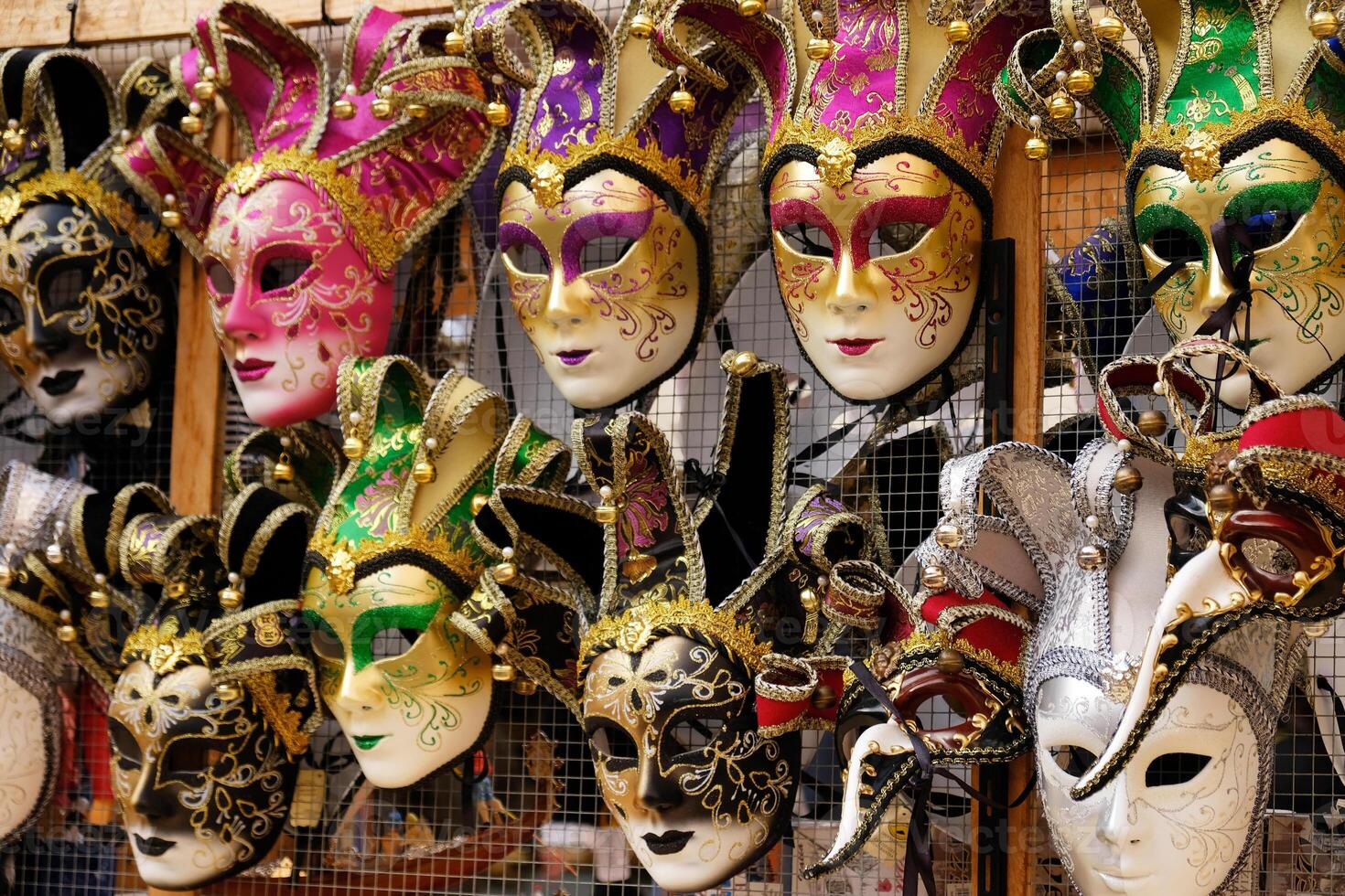 Traditional venetian masks on shelves in souvenirs shop in Venice, Italy. Beautiful carnival masks in variety of colours. Authentic and original Venetian full-face masks for Carnival. photo