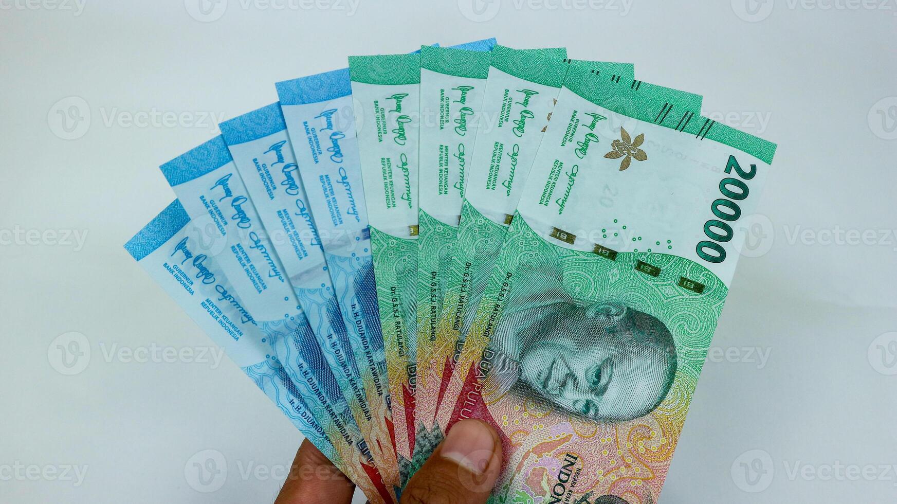 New Rupiah issued in 2023. Indonesian money bank notes isolated on white backgrounds. photo