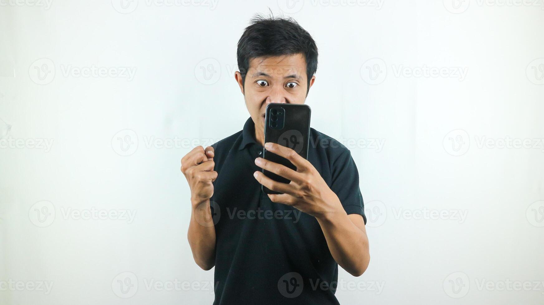 Disappointed, not expect, angry expression of asian man reading bad news at mobile phone isolated on white background. photo