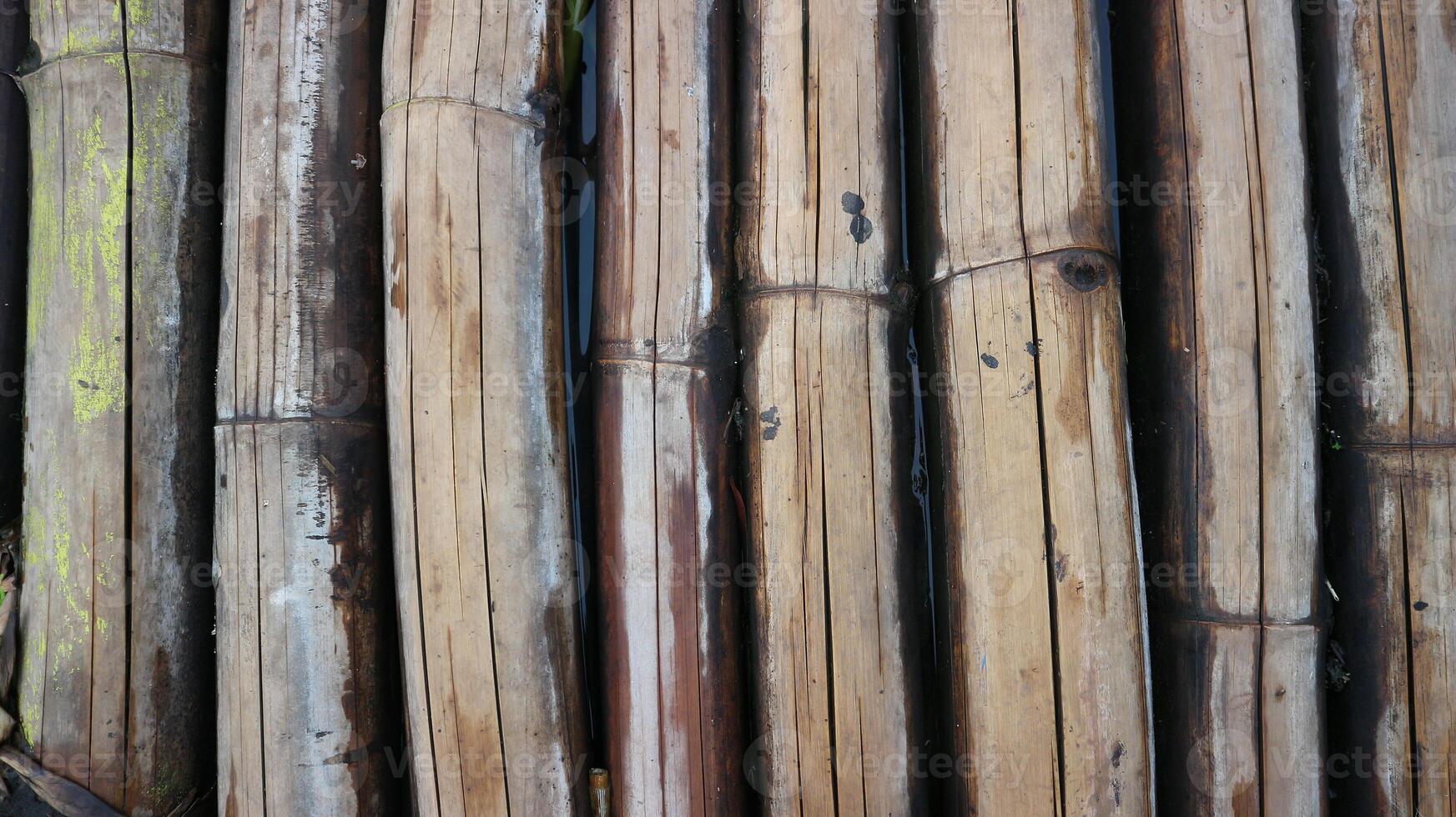 The texture under the background of dried bamboo is grey, vertically positioned. photo