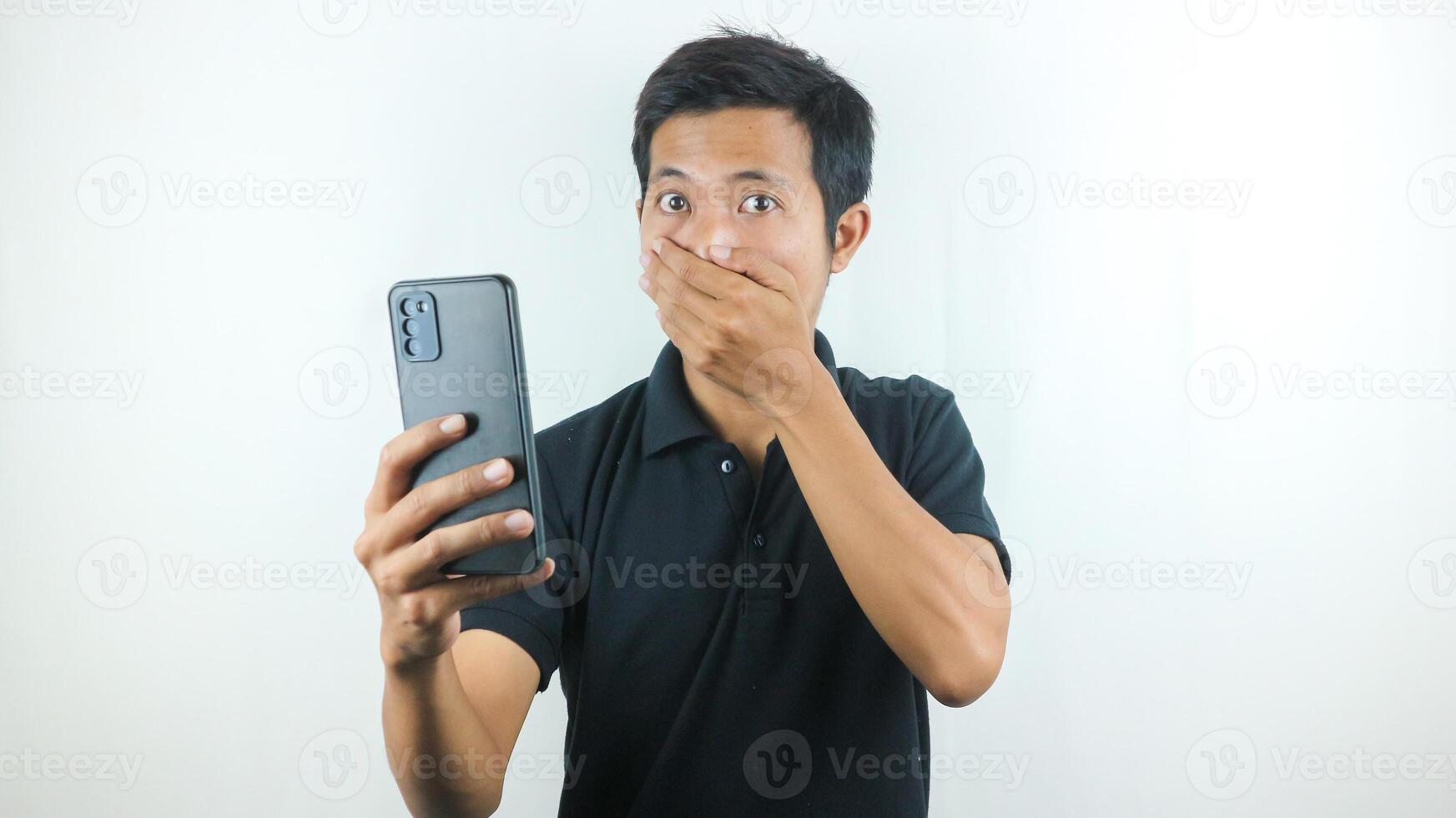 Disappointed, not expect, angry expression of asian man reading bad news at mobile phone isolated on white background. photo