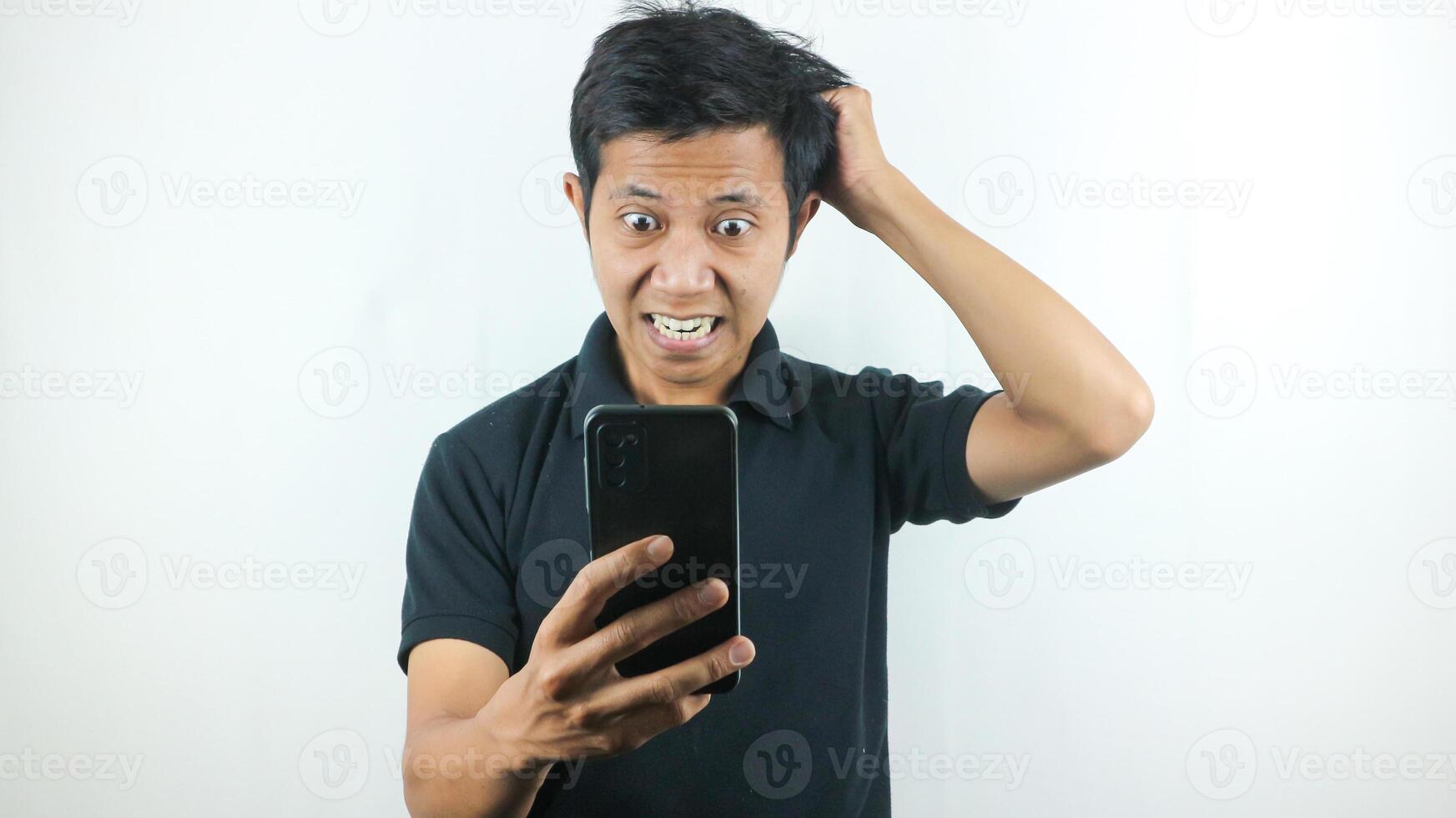 Disappointed, not expect, angry expression of asian man reading bad news at mobile phone isolated on white background. photo