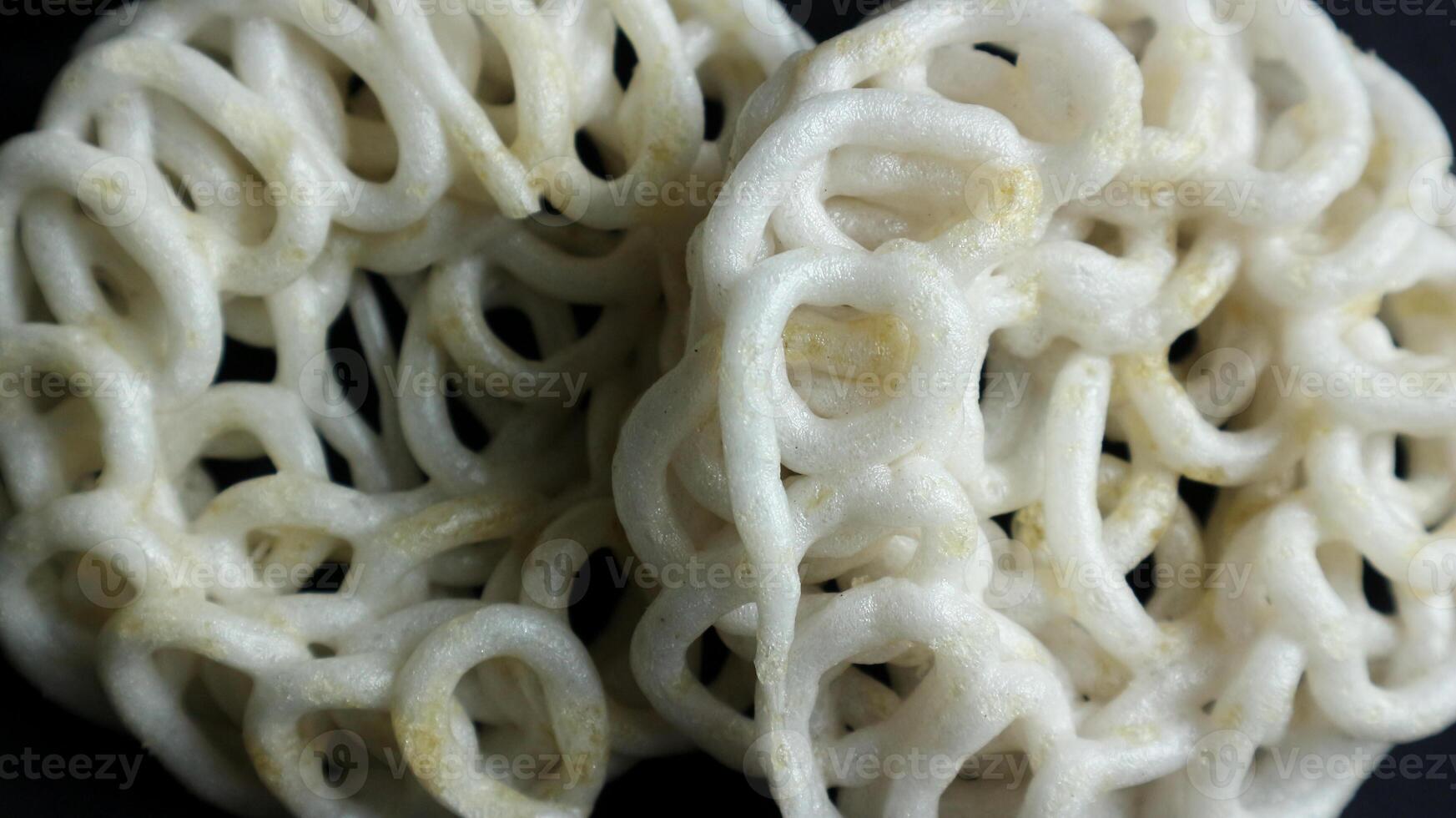 Krupuk or kerupuk Indonesian are deep fried crackers made from starch and other ingredients that serve as flavoring. photo