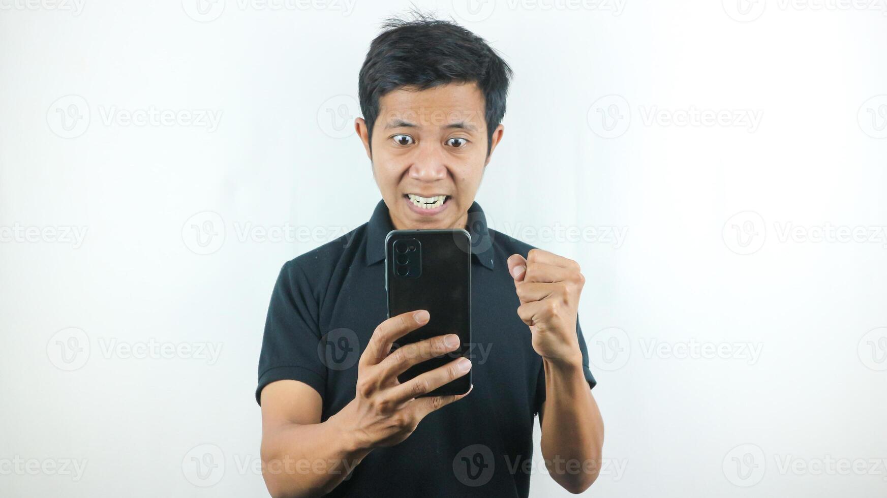 Disappointed, not expect, angry expression of asian man reading bad news at mobile phone isolated on white background. photo