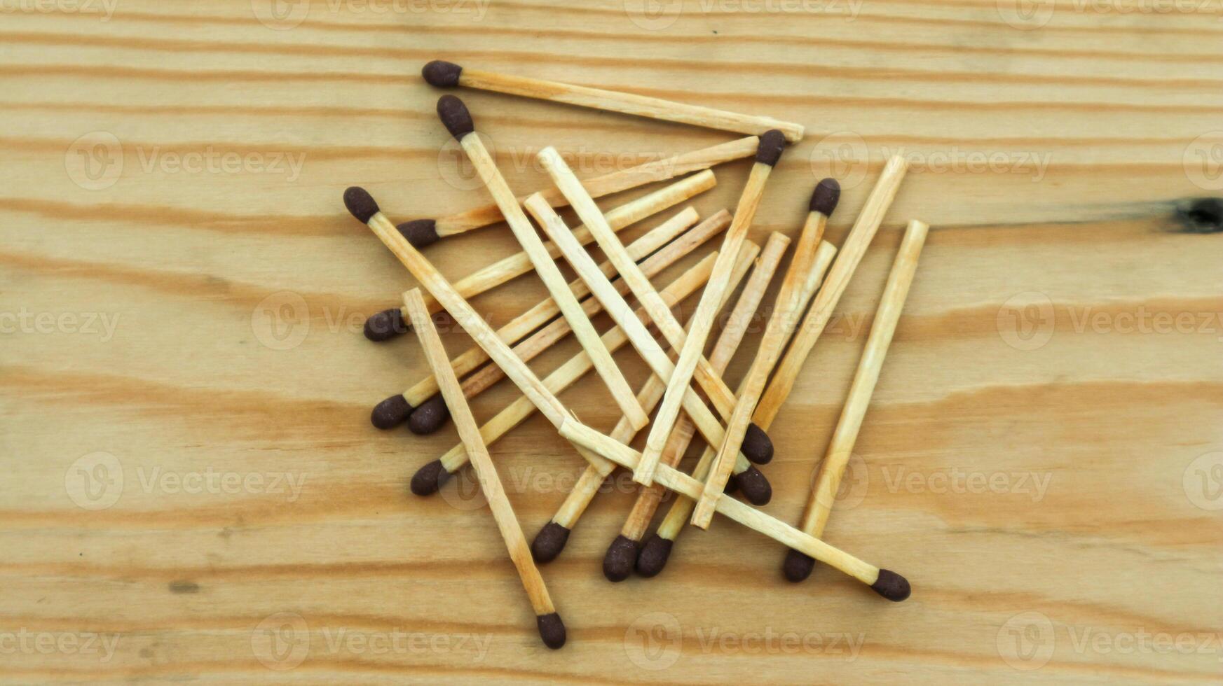 Wooden match sticks isolated on wooden table. photo