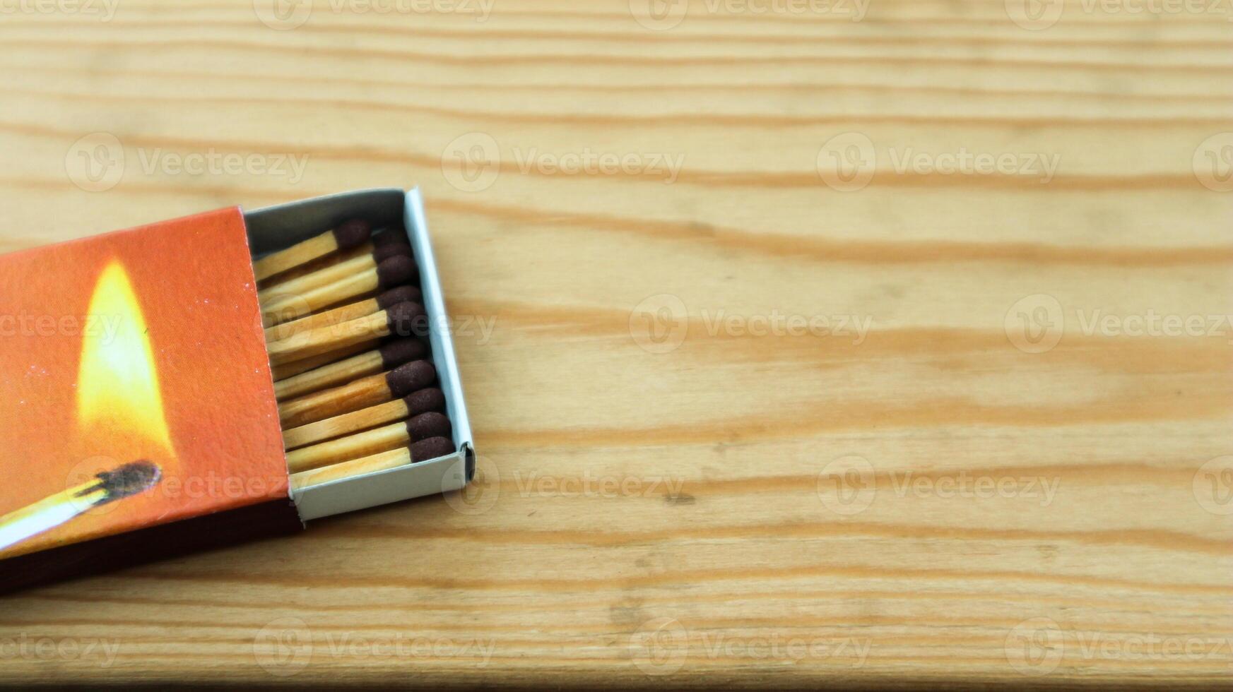Wooden match sticks isolated on wooden table. photo