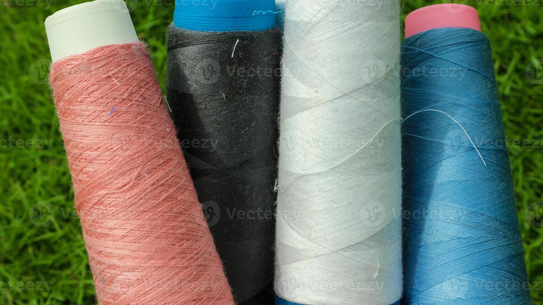 Colorful yarn spools used in the fabric and textile industry photo