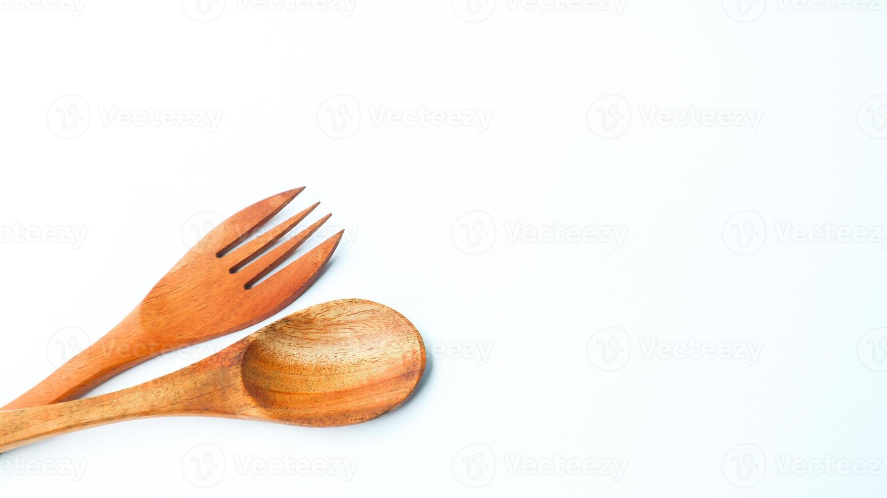 Wooden spoon and fork isolated on white background. Kitchen and cooking concept. photo