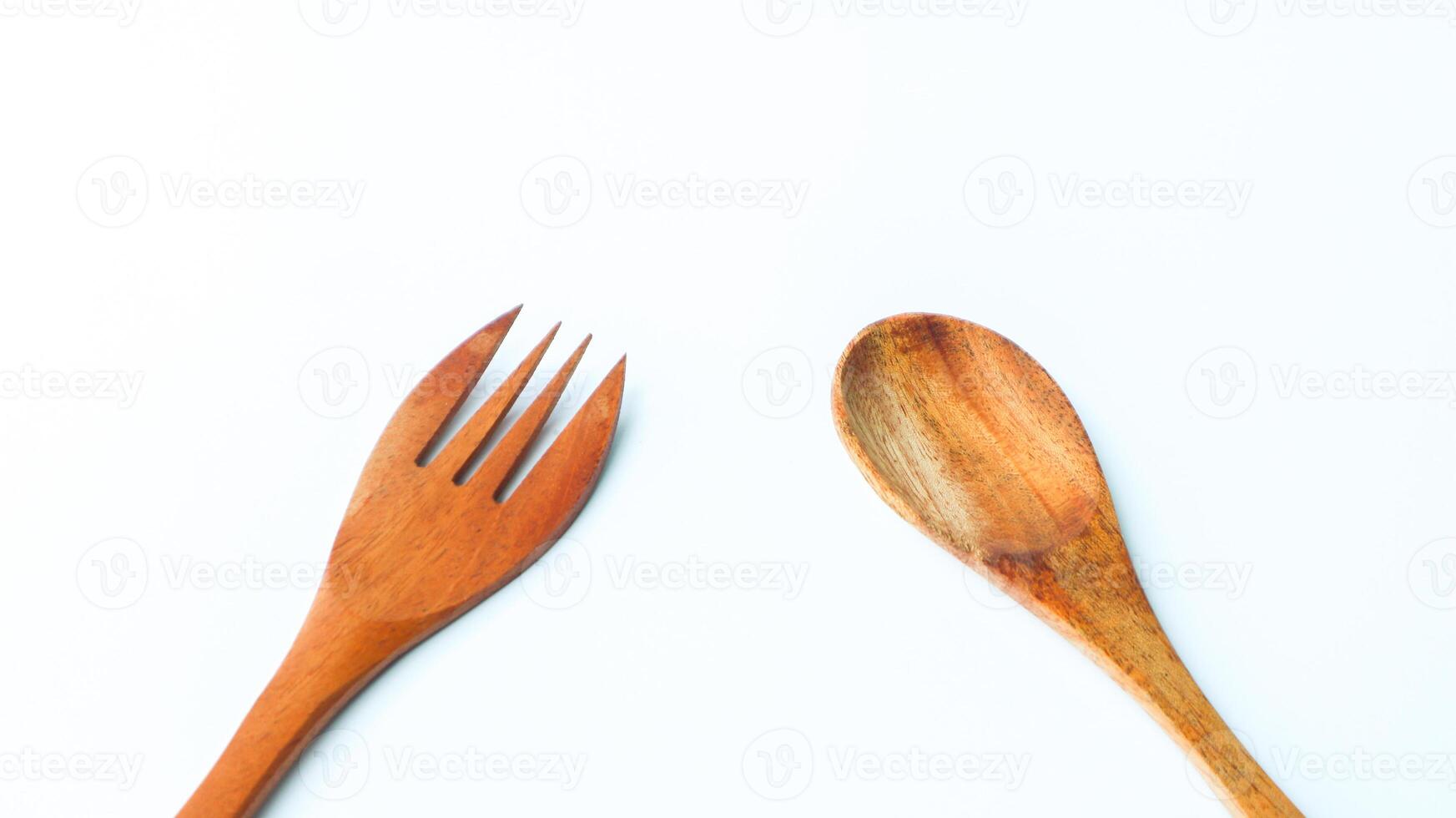 Wooden spoon and fork isolated on white background. Kitchen and cooking concept. photo