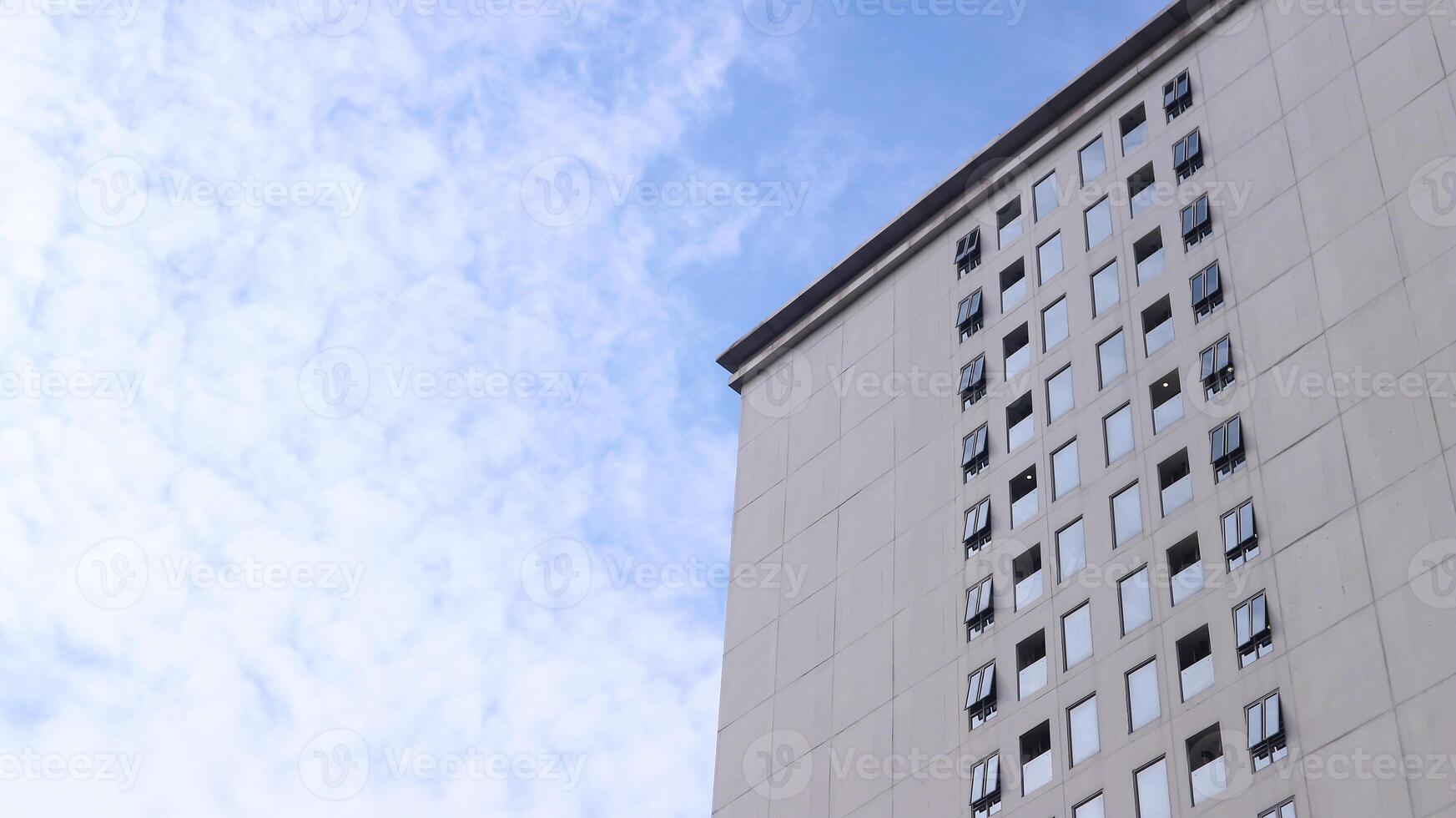 A towering building with a glass window exterior outside. photo