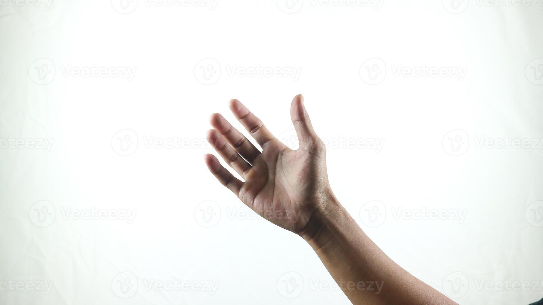 hand holding something like a bottle or smartphone on a white background photo