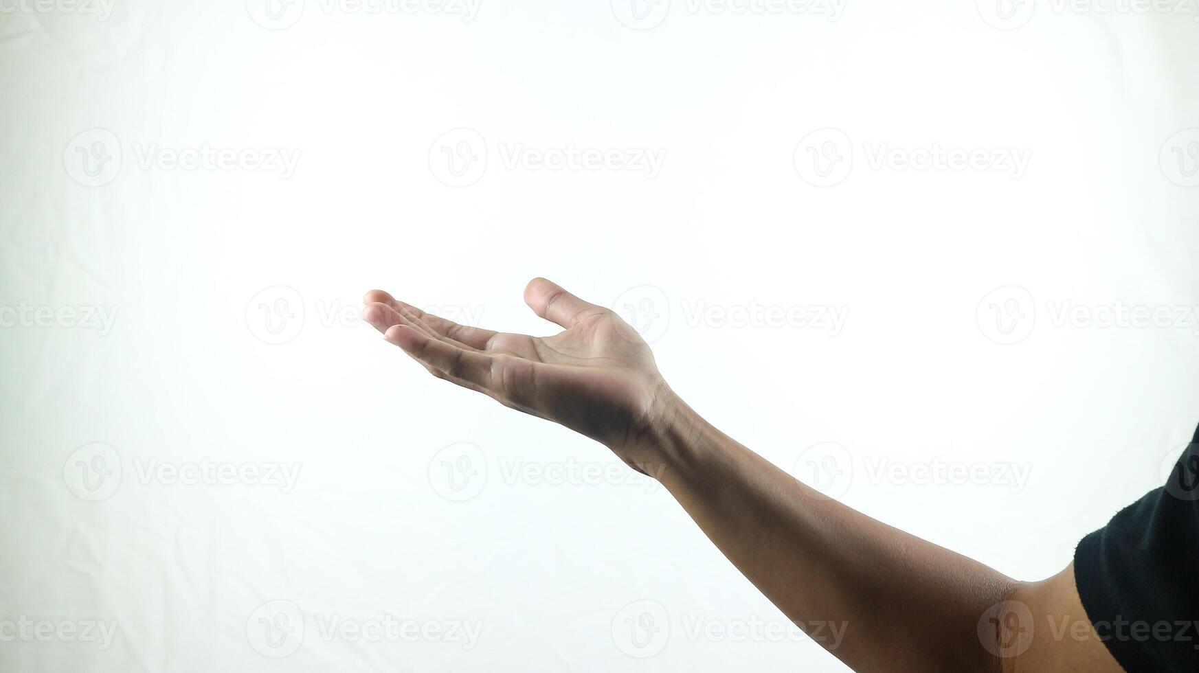 Human hand in choosing gesture isolate on white background with clipping path. Hand symbol reaching for something, A palm in front of black background photo