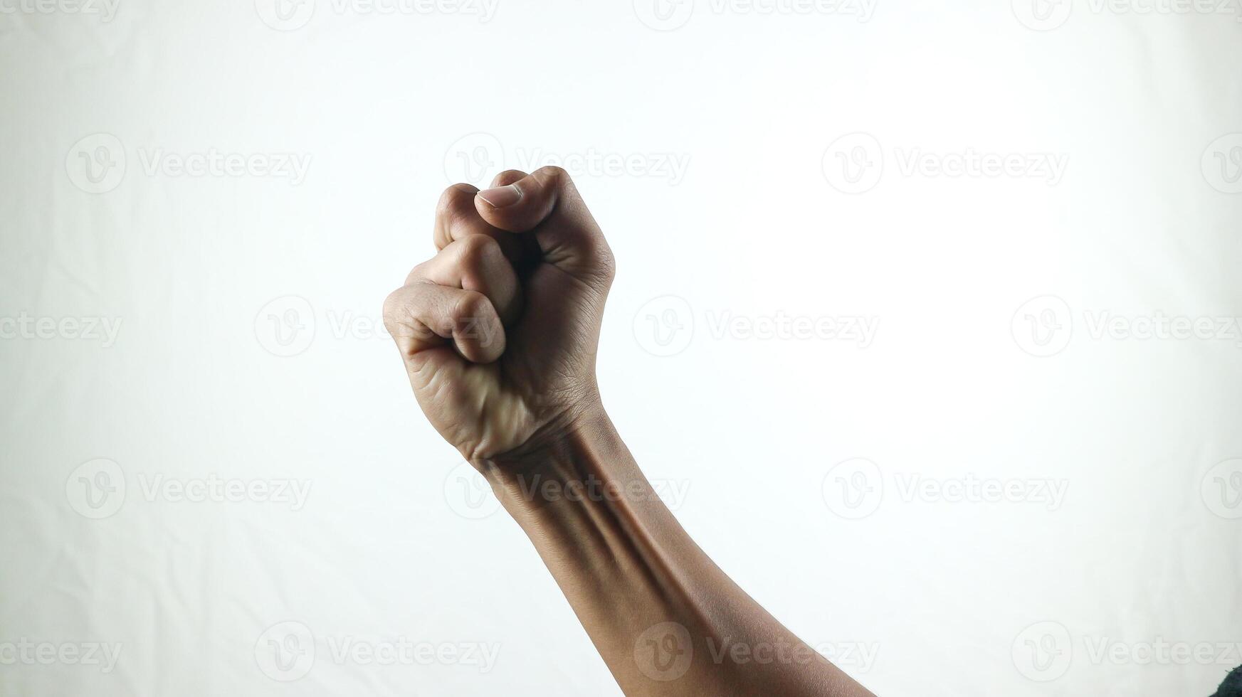 Counting, aggression, brave concept. Black male fist, clenched hand, strong male man raised fist power, protest, fist ready to fight isolated on white background. photo