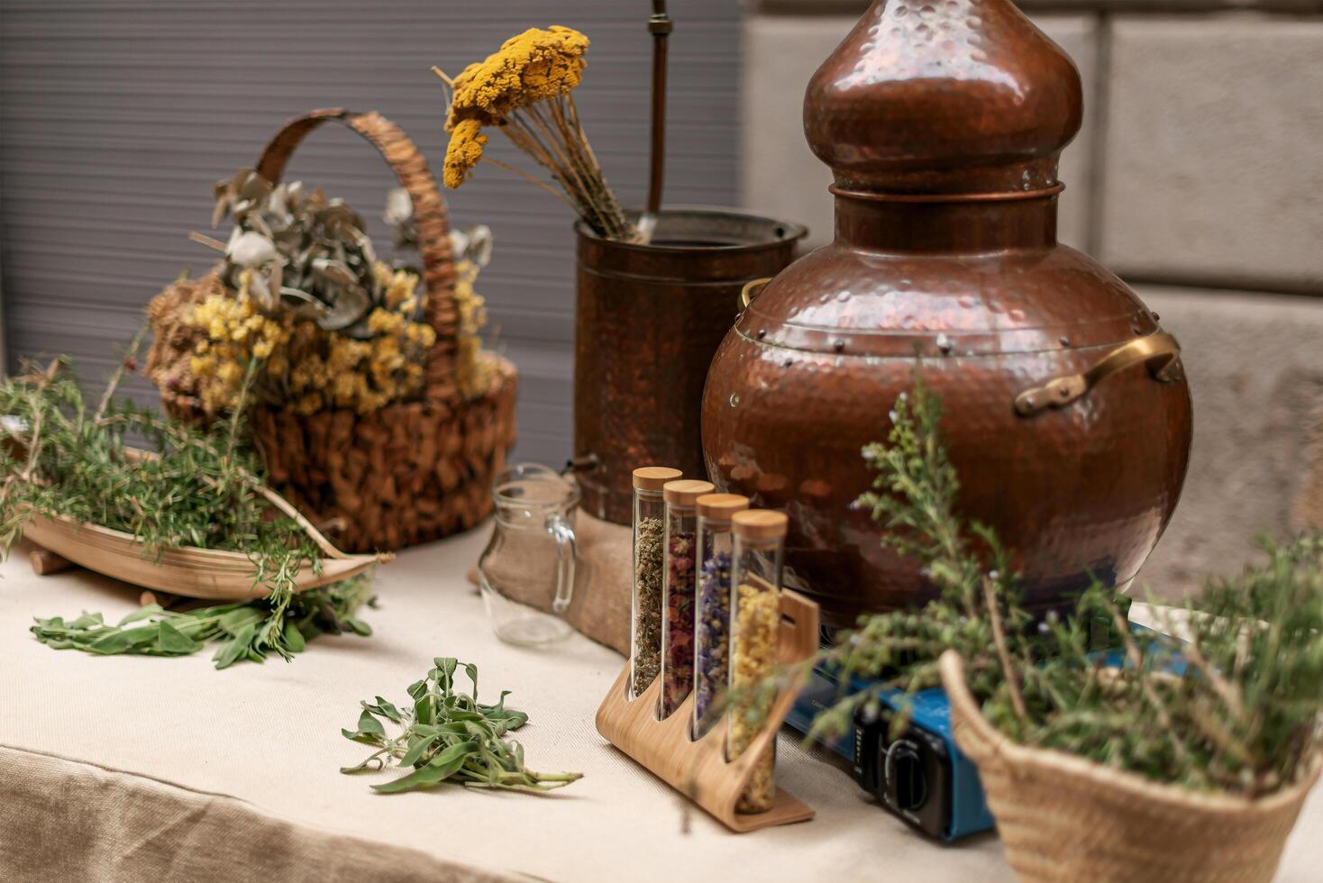 Herbal bench and old copper essential oil distiller photo