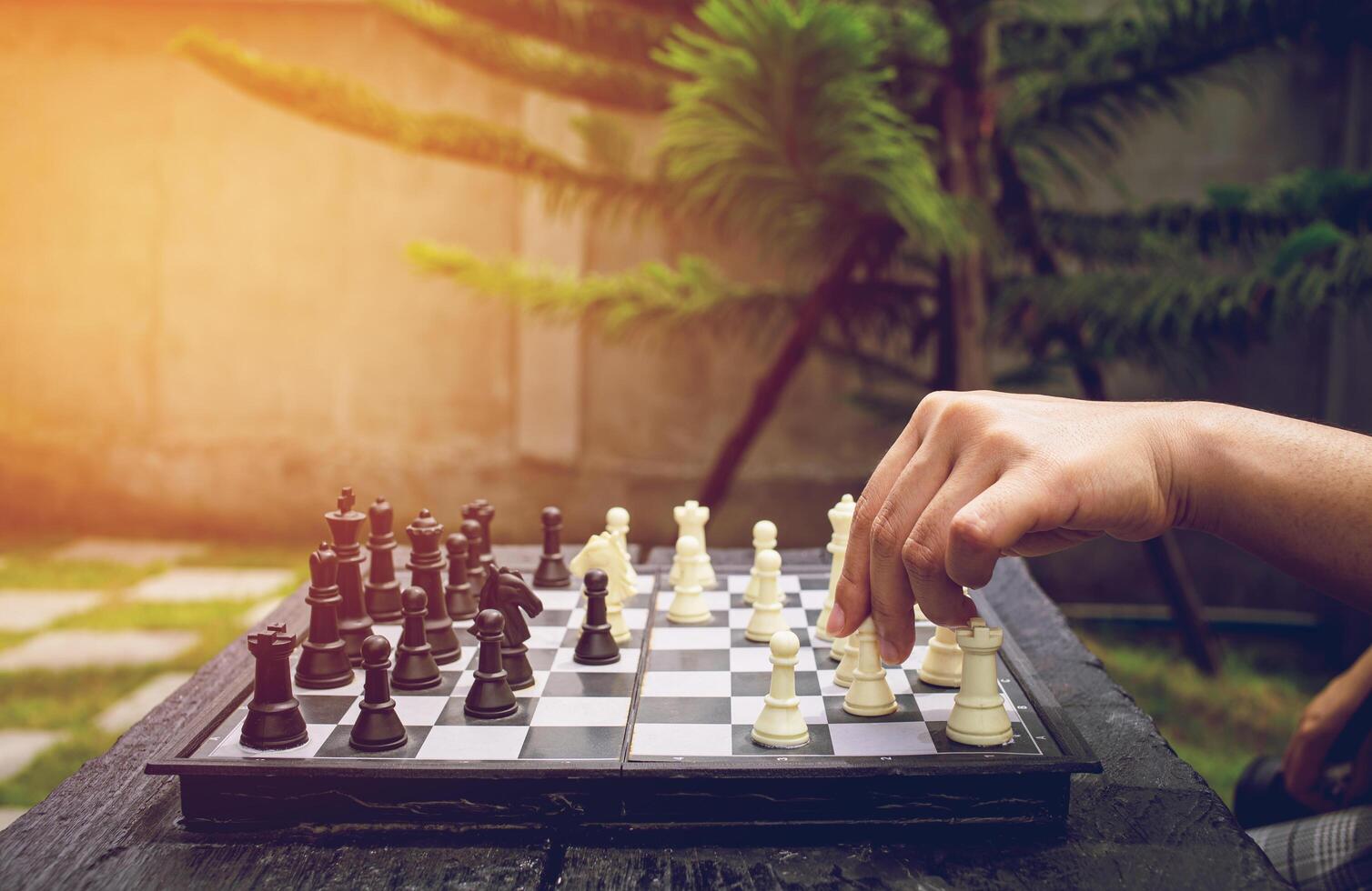 Close-up of female hands playing chess game Smart planning. Using concepts and Business articles photo