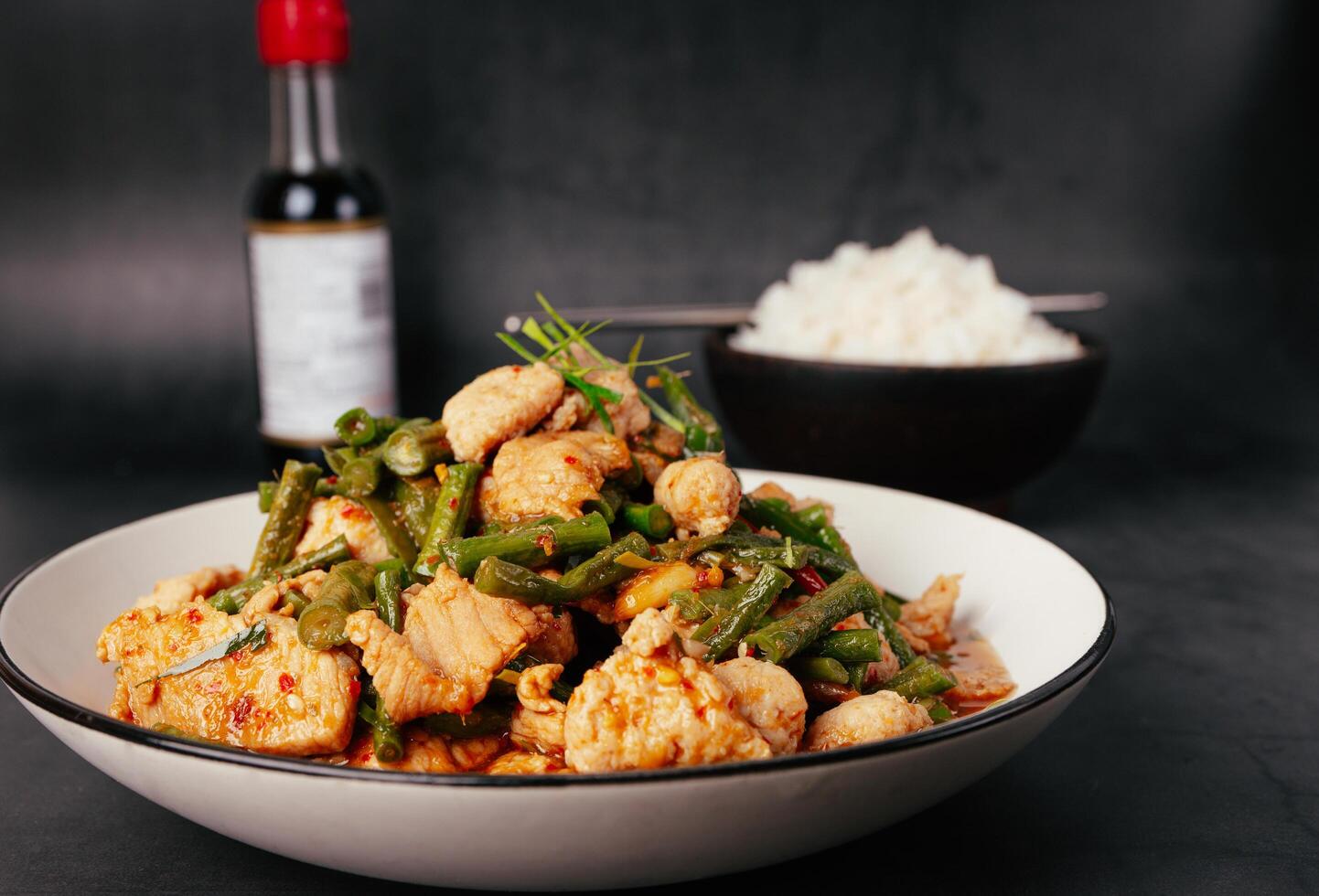 Close up, Tasty Stir-fried pork and red hot curry paste with or long bean and Ingredients are oyster sauce, fish sauce, sugar, kaffir lime leaves in the dish Eat with cooked rice. Thai food photo