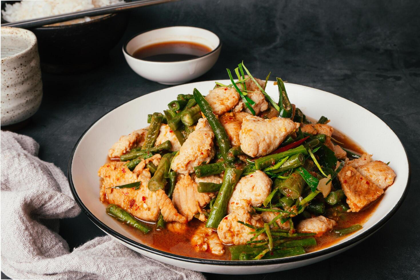 Close up Tasty Stir-fried pork and red hot curry paste with or long bean and Ingredients are oyster sauce, fish sauce, sugar, kaffir lime leaves in the dish Eat with cooked rice. Thai food photo