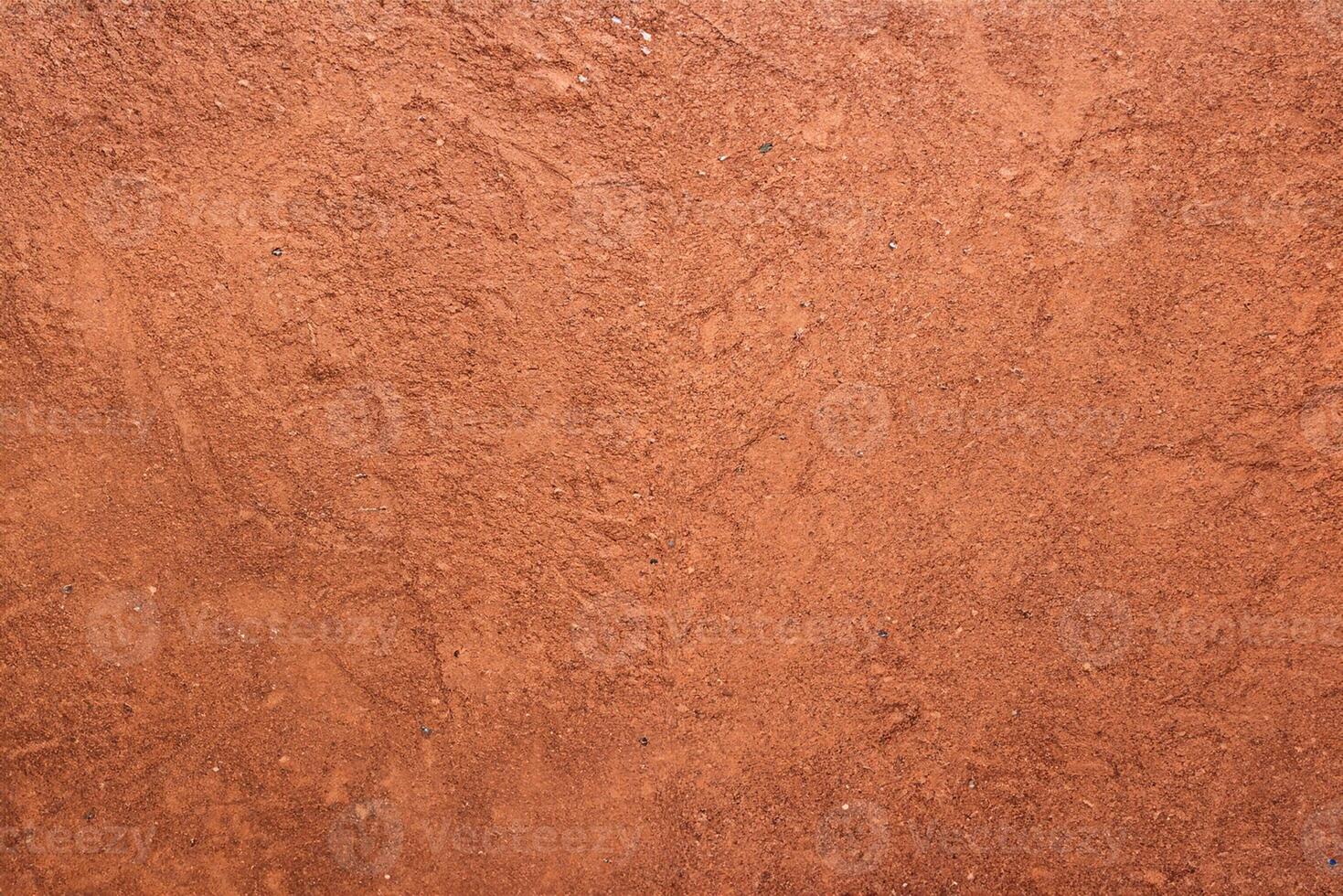 Red sand texture with shoe prints on top photo