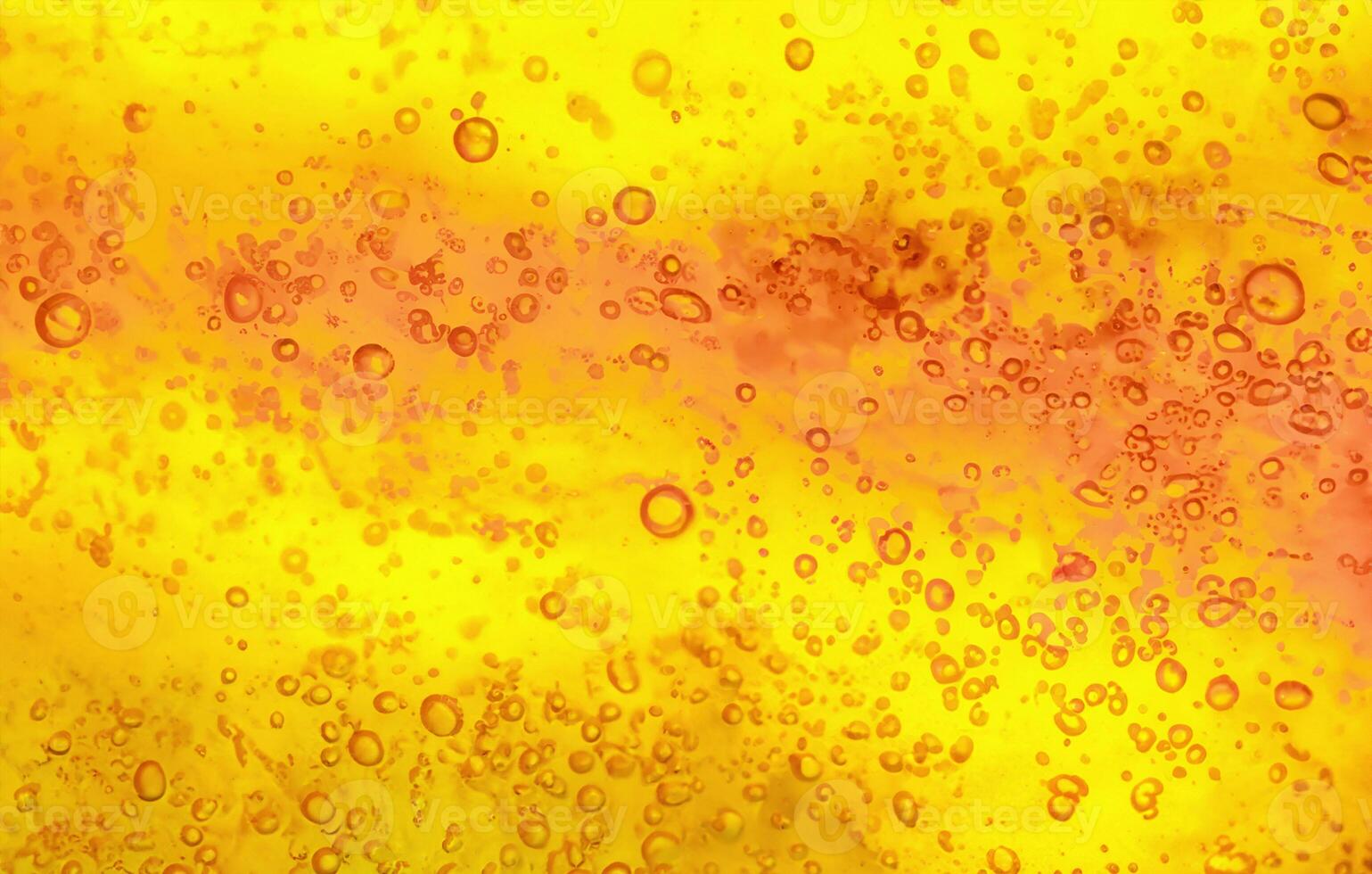 Abstract textured gel background. Yellow and orange liquid with bubbles. photo