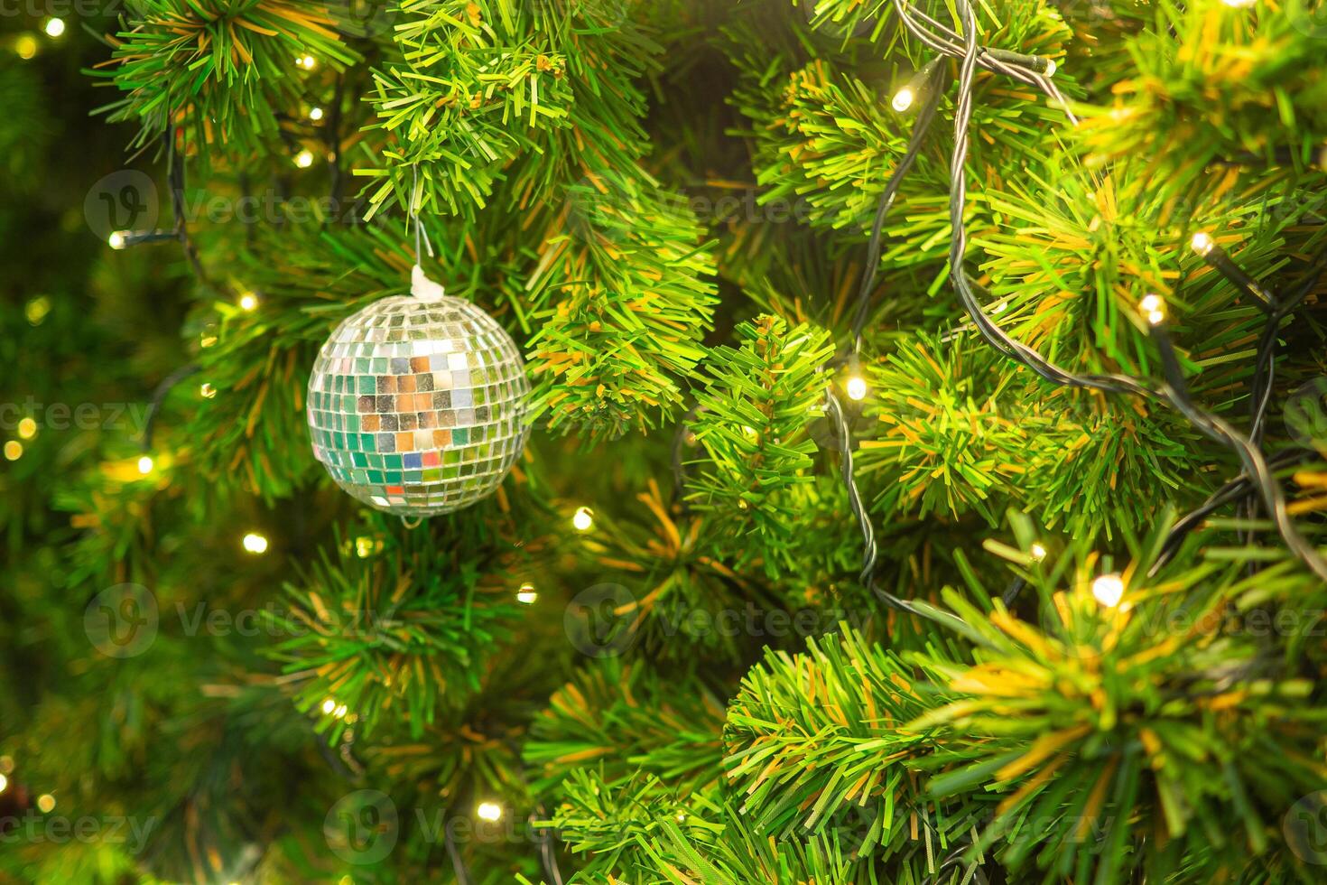 Bright and abstract blurred colorful on Christmas tree with shimmering glitter, defocused background photo