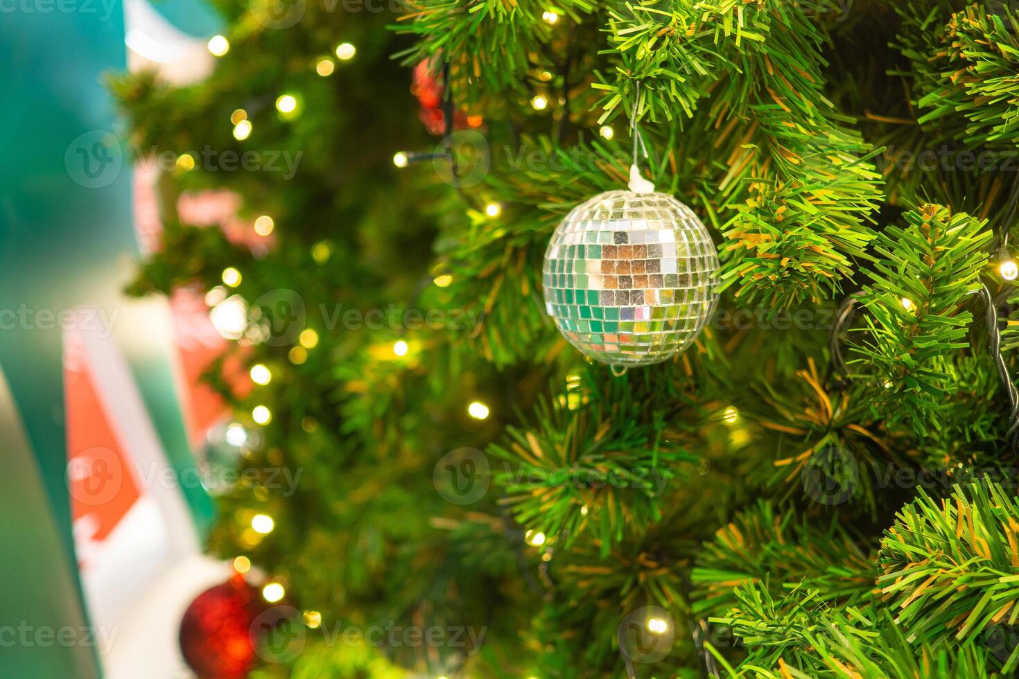 Bright and abstract blurred colorful on Christmas tree with shimmering glitter, defocused background photo