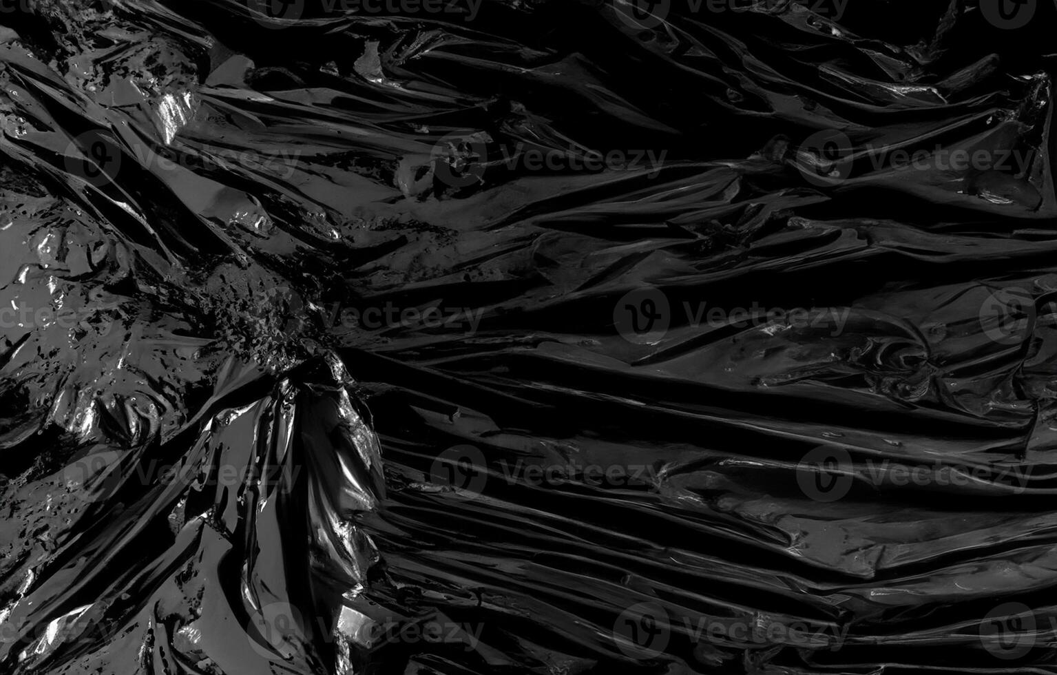 a transparent plastic wrap on black background. realistic plastic wrap texture for overlay and effect. wrinkled plastic pattern for creative and decorative design. photo