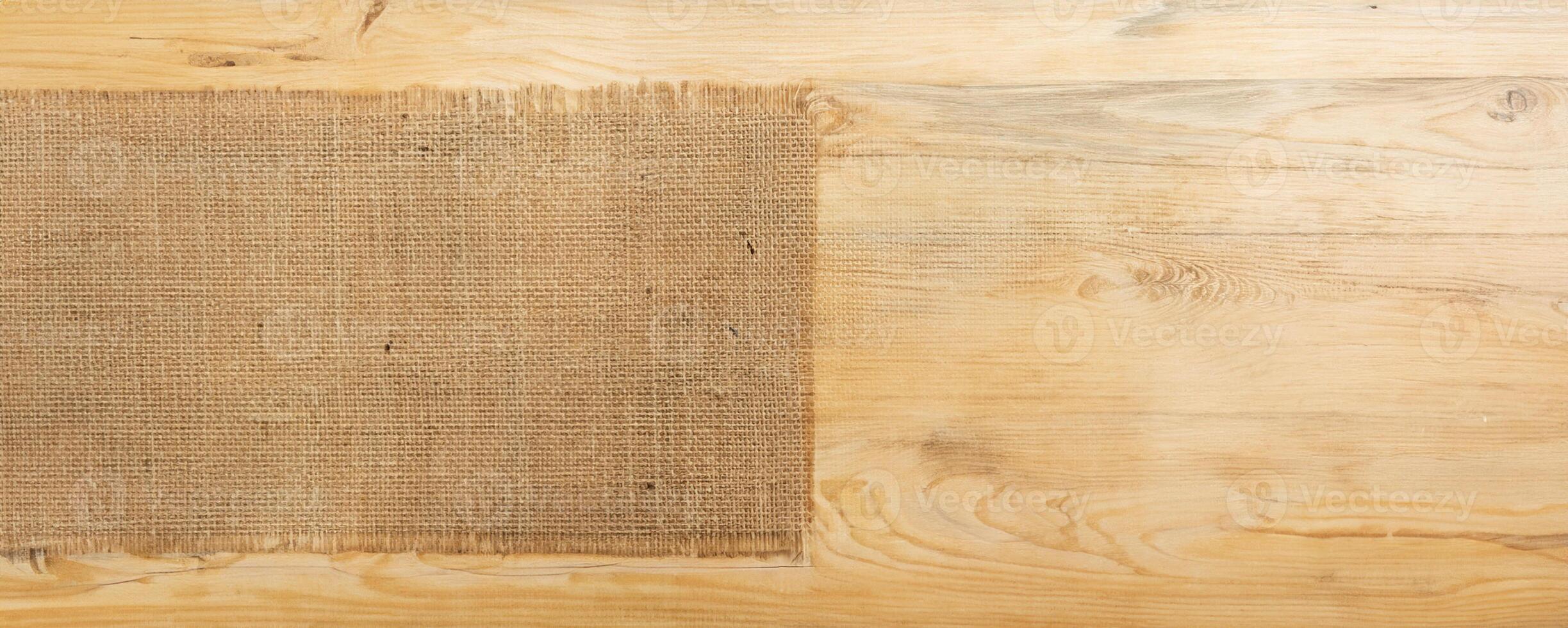 burlap hessian sacking on wooden background photo