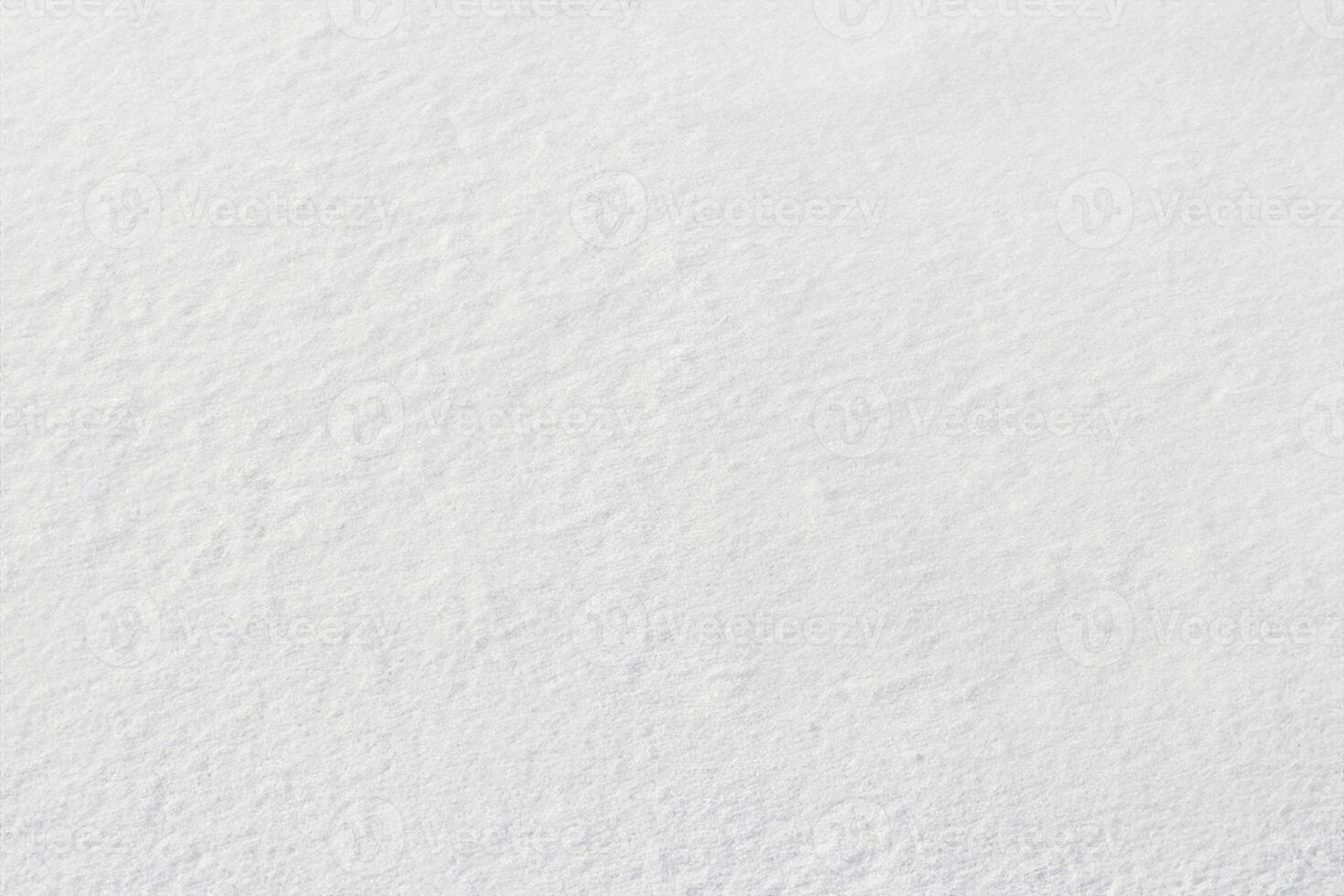 Uniform snow cover. Snow texture on a flat plot of land photo