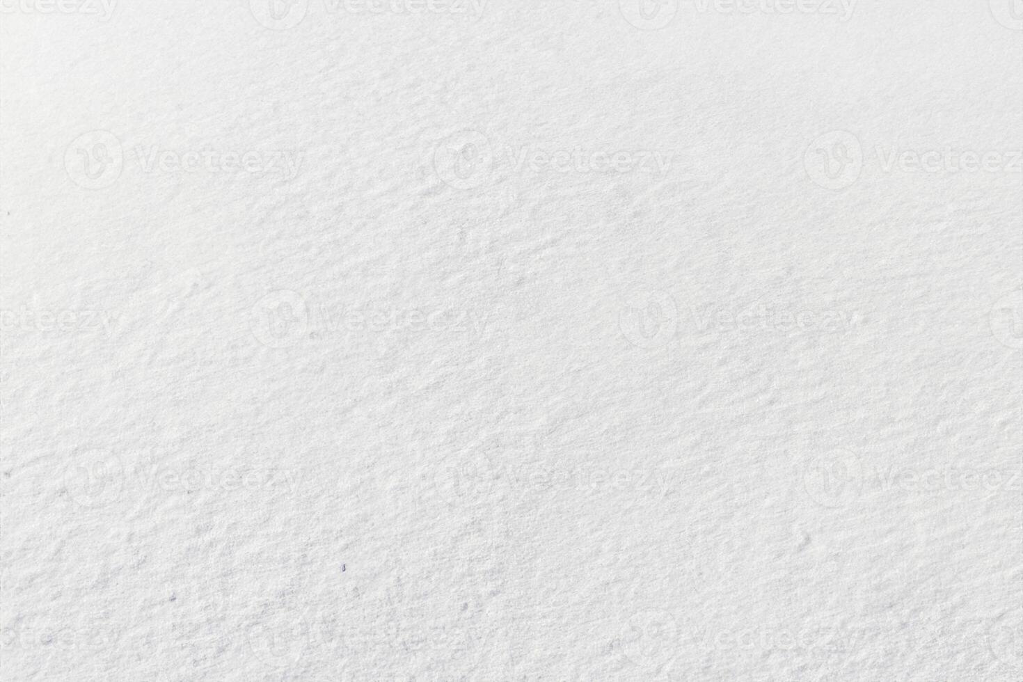 Uniform snow cover. Snow texture on a flat plot of land photo
