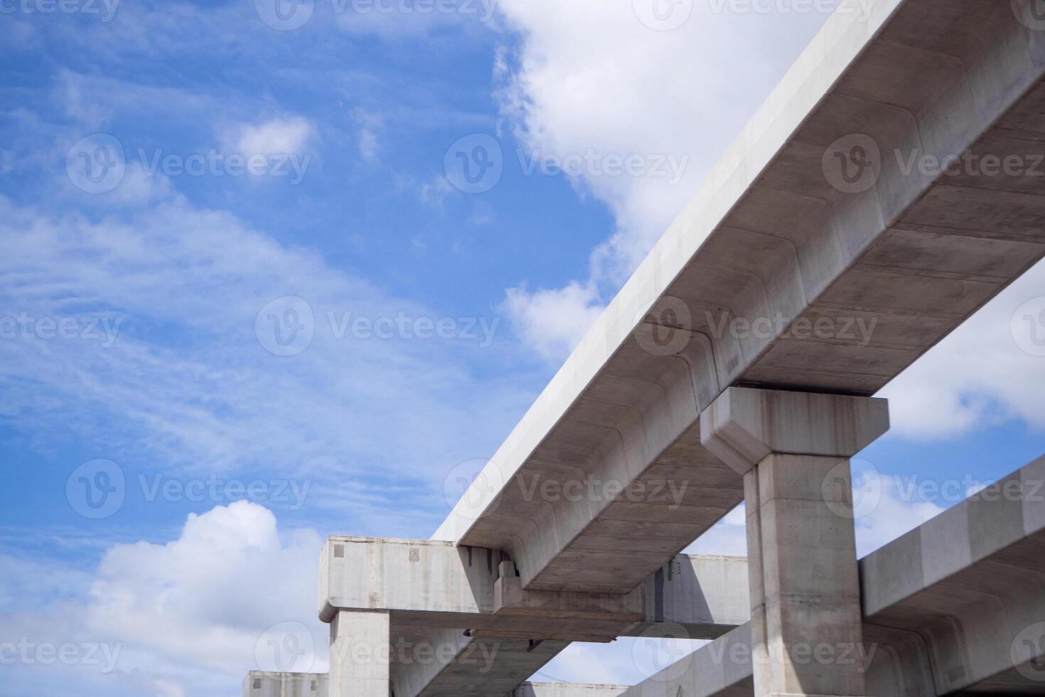 Bottom view of BTS Skytrain tracks in Bangkok, Thailand. With beautiful sky and clouds background. Built with a strong concrete structure by construction from the company experienced photo