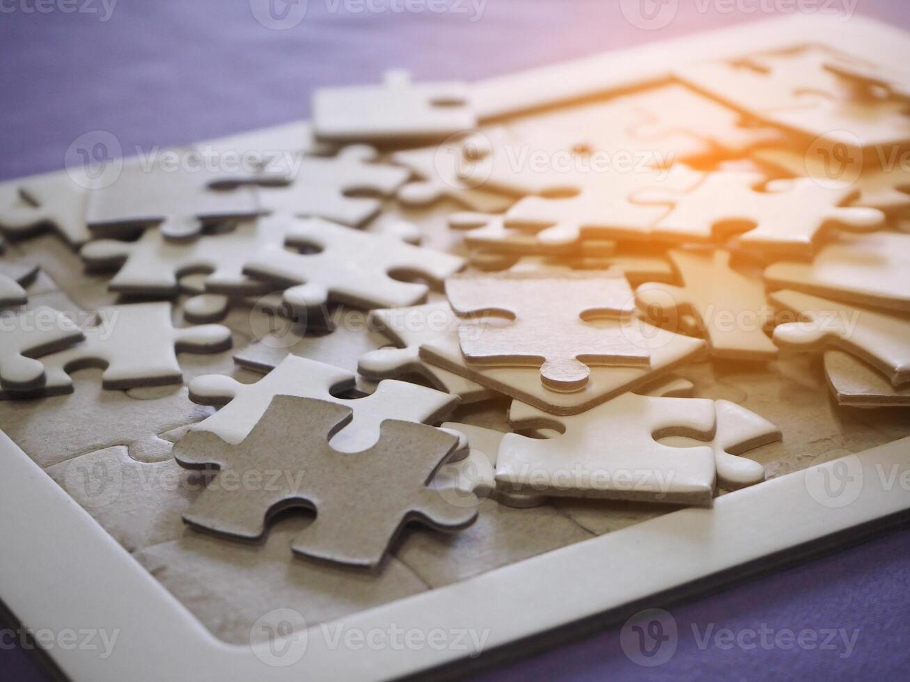 Jigsaw puzzle with sunlight effect. Space for text photo