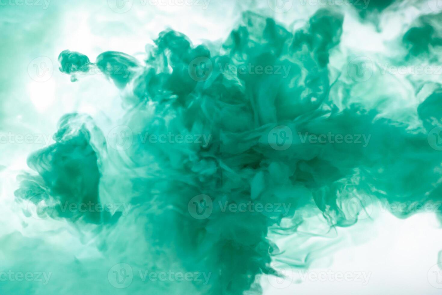 Green smoke bomb exploding against white background photo