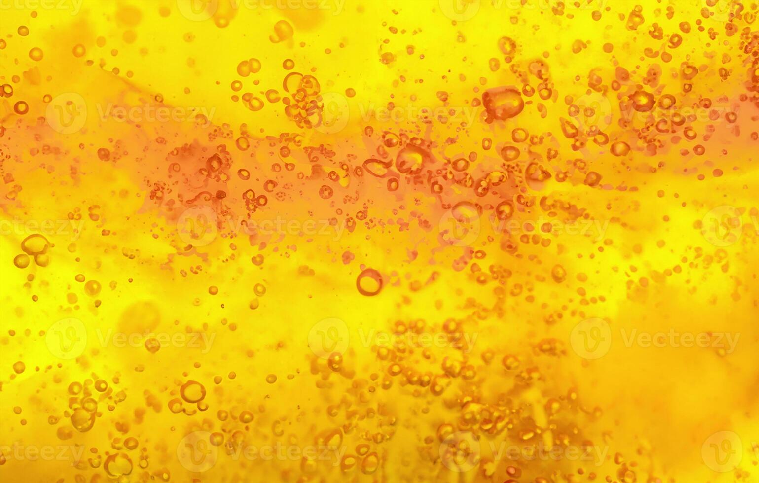 Abstract textured gel background. Yellow and orange liquid with bubbles. photo