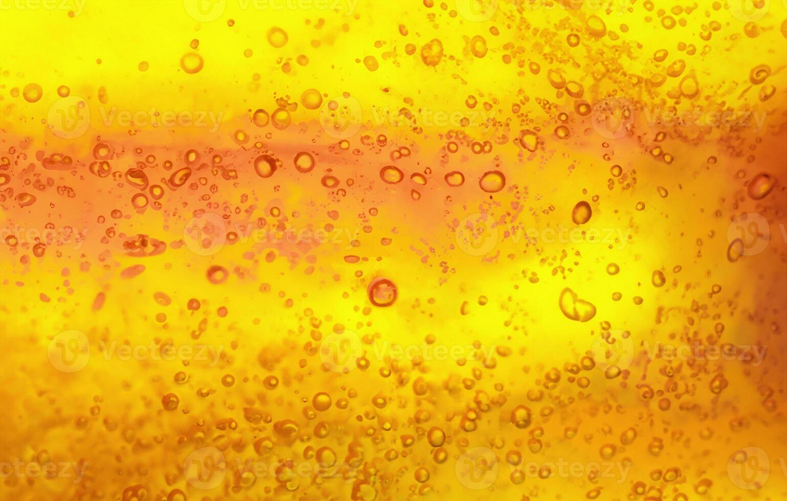 Abstract textured gel background. Yellow and orange liquid with bubbles. photo