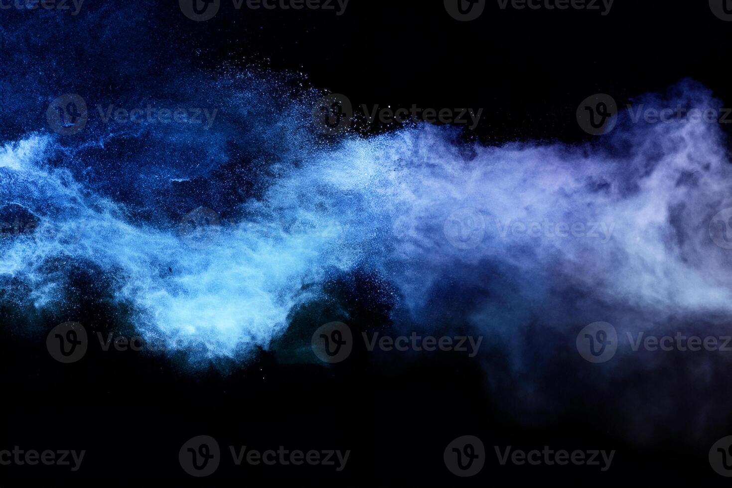 Abstract brown powder explosion. Closeup of blue dust particle splash isolated on black background. photo