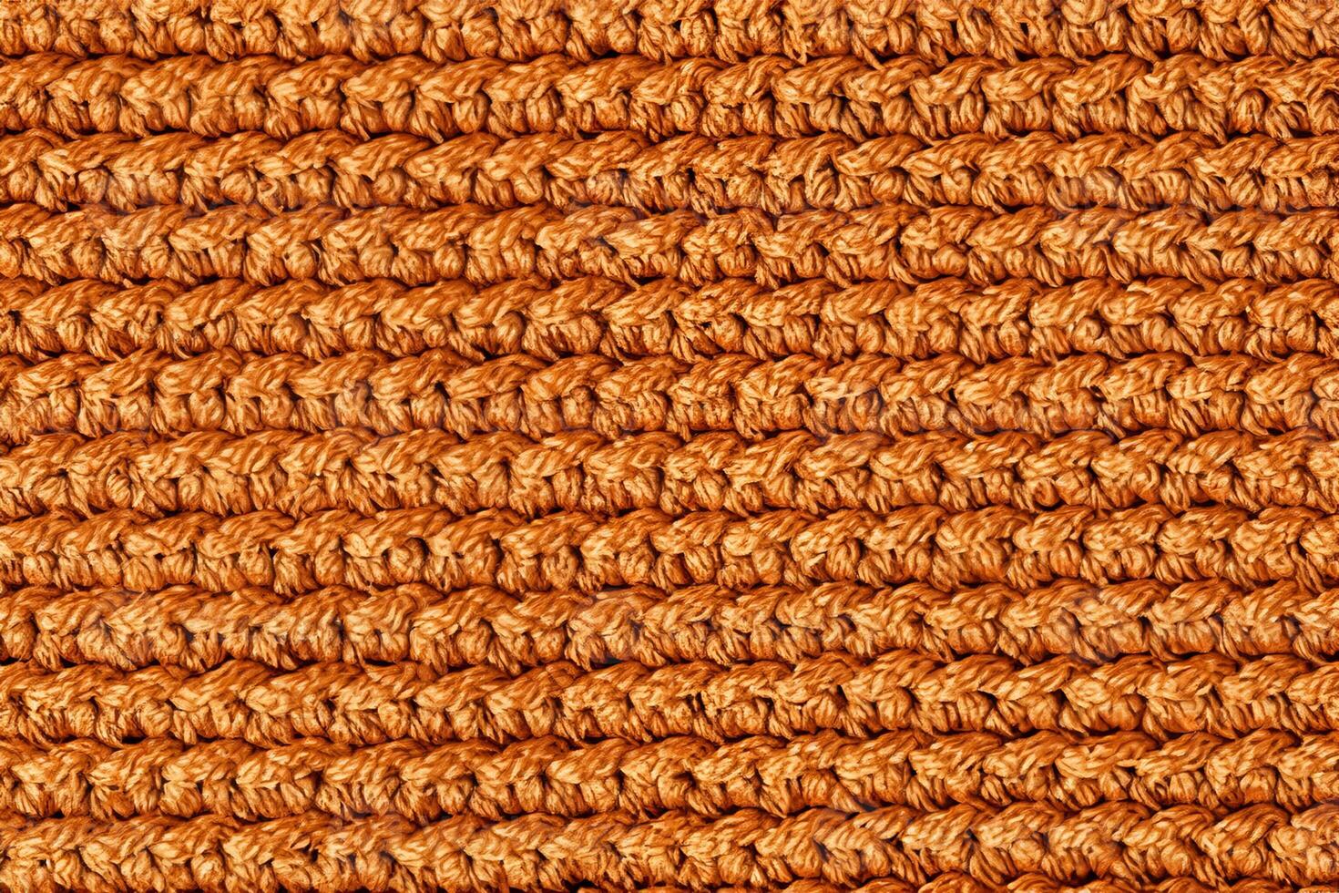 Orange knitted fabric texture background. Top view. Copy, empty space for text photo