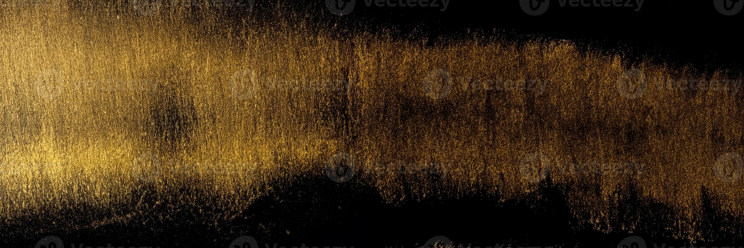 Golden traces of a stroke with an acrylic paint with an art brush on a black background. photo