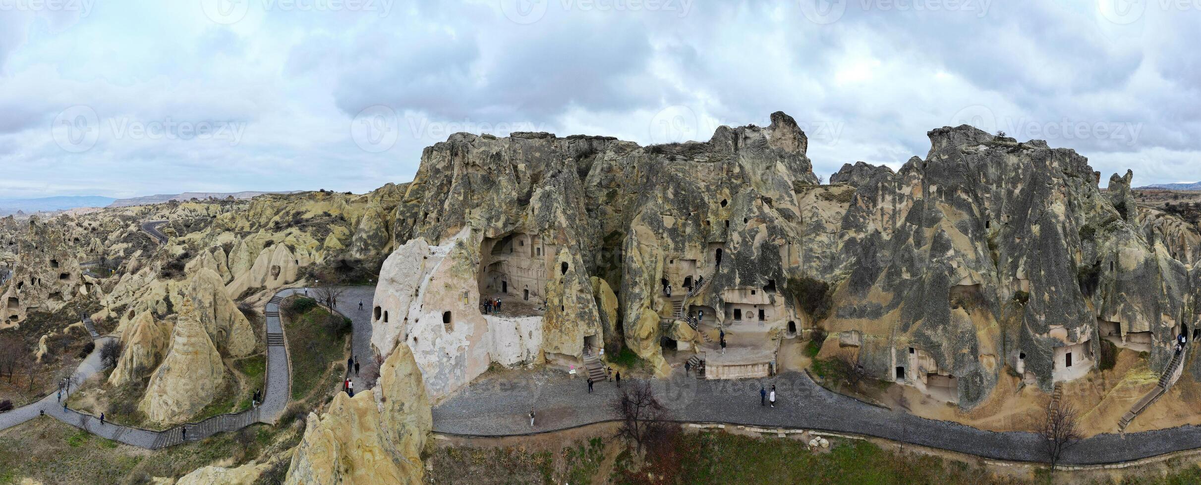Panoramic view of the Goreme Open Air Museum in Cappadocia, Turkey. This Unesco World Heritage site is an essential stop on any Cappadocian itinerary. Tourists visiting the historical site. photo